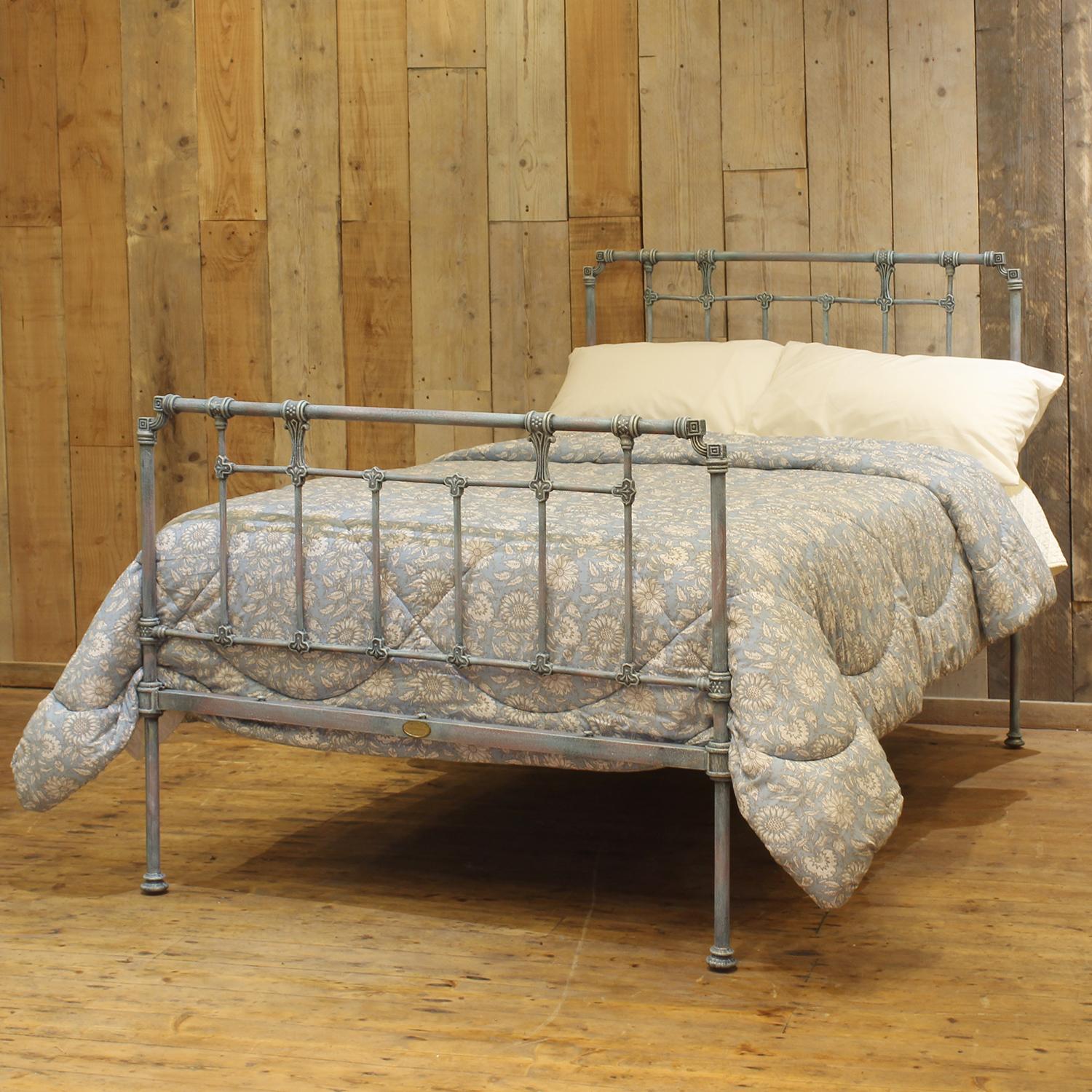 A small double Victorian cast iron bedstead finished in blue verdigris with attractive castings. 

This bed accepts a small double size 4ft wide (48 inch or 120cm) base and mattress. 

The price includes a firm standard bed base to support the