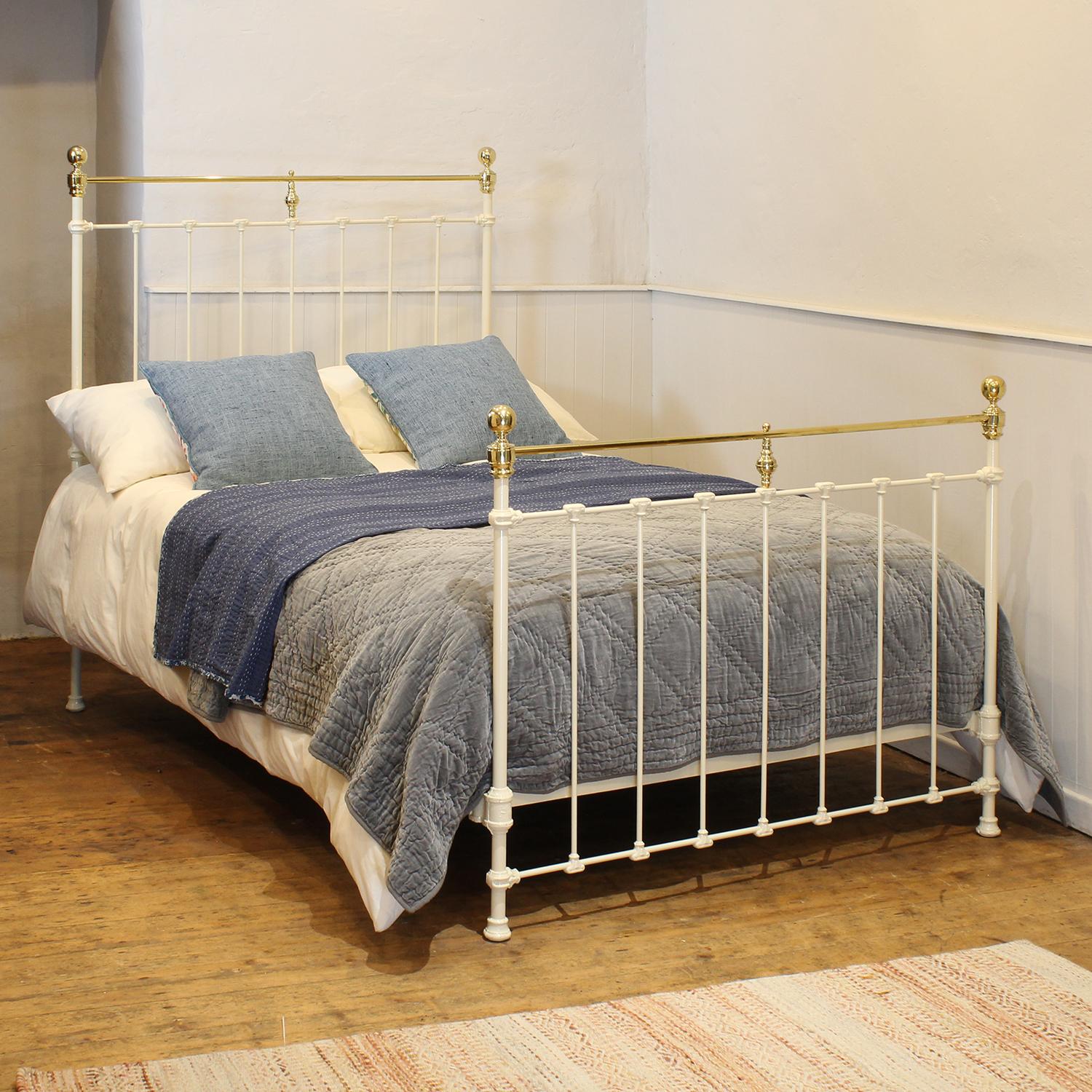 Victorian brass and cast iron bedstead finished in cream with straight brass top rails and decorative castings.

This bed accepts a double size 4ft wide (48 inch or 120cm) base and mattress. 

The price includes a firm standard bed base to
