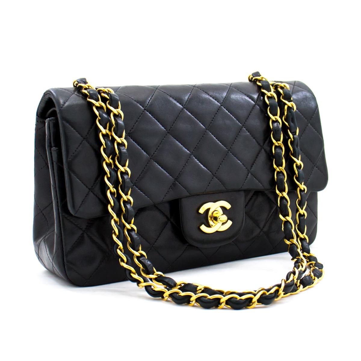 This pre-owned classic Chanel 9 inch double flap bag from 1996-1997 has been crafted from diamond-quilted lambskin with a double flap closure. The front flap features the Maisons signature CC logo on a twist-lock finished with refined gold-tone