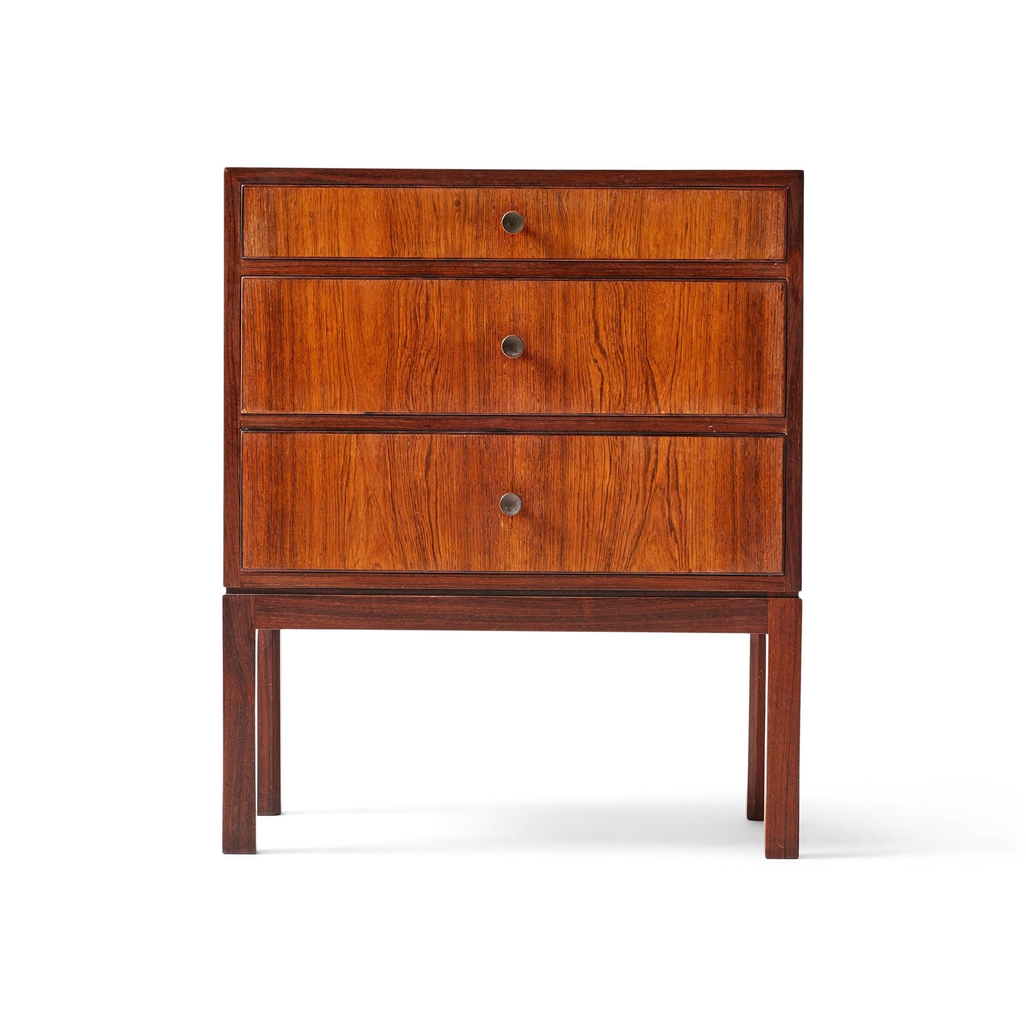 Pequeño mueble de tres cajones en madera de palisandro.