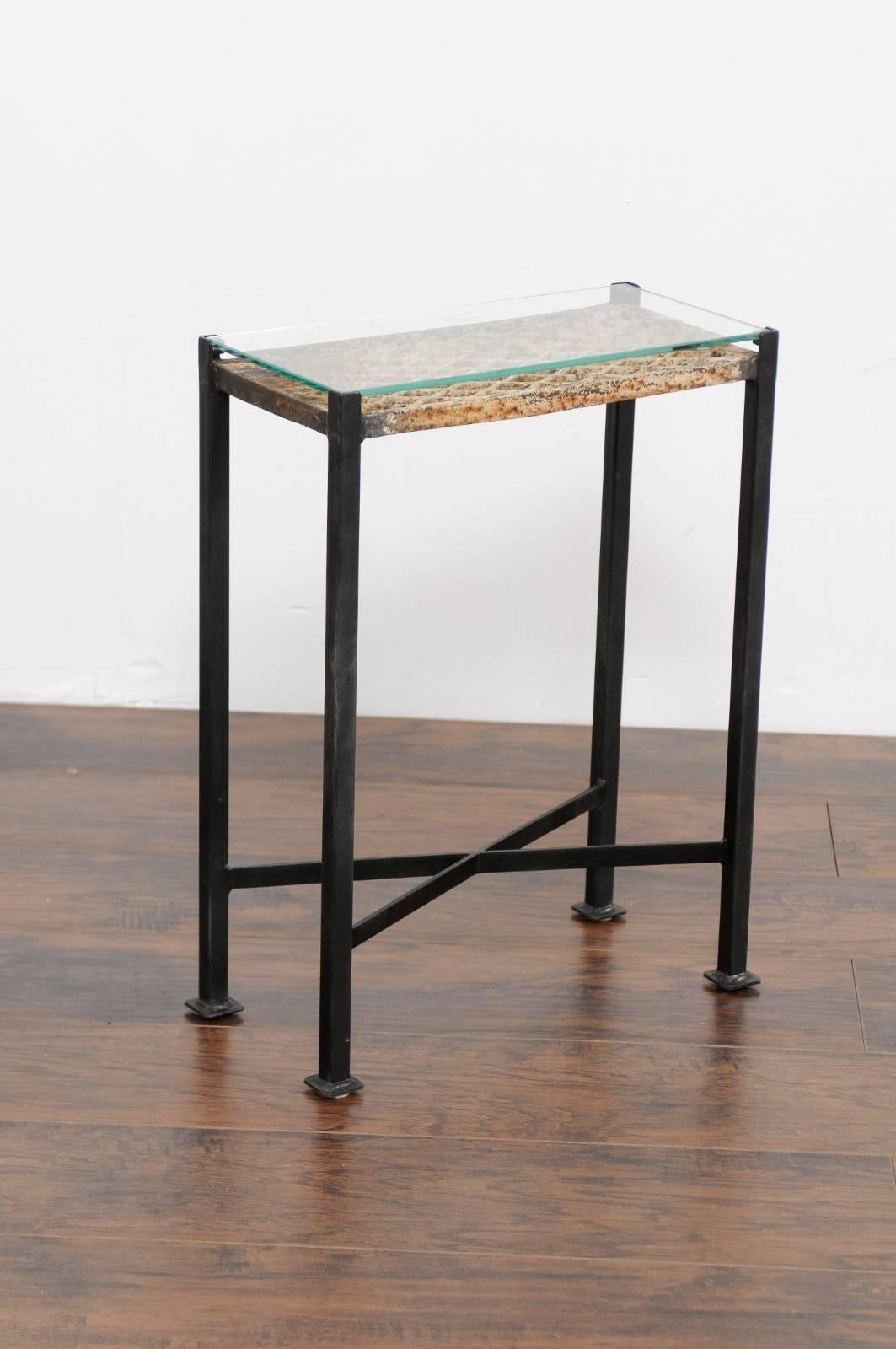 A petite rectangular drink table made from a French decorative iron ornament from the 1st half of the 20th century, protected by a custom glass top and mounted on a custom base. This small drink table features a rectangular glass top, protecting an