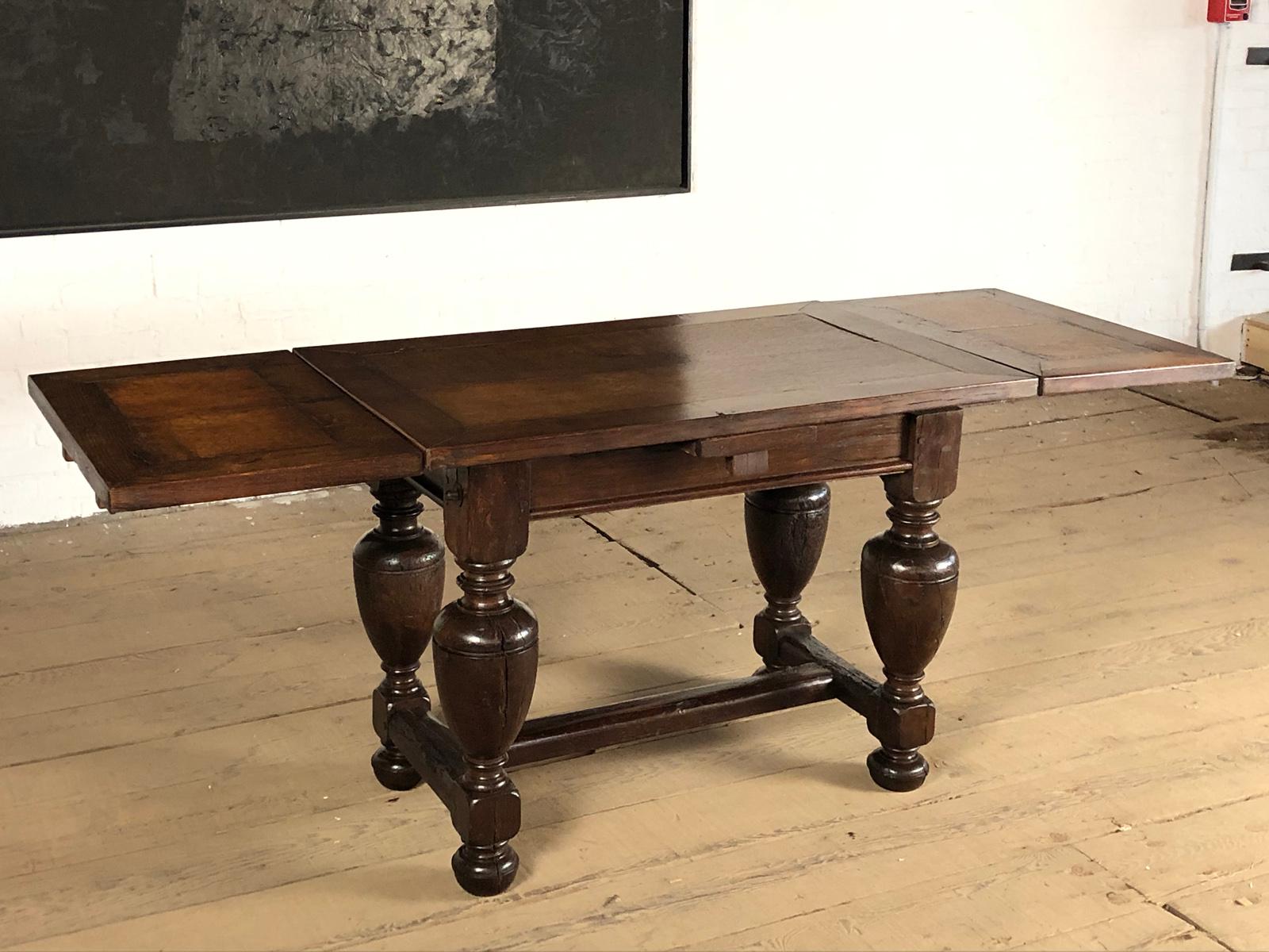 The small Dutch Baroque draw-leaf or center table with a two-board framed top having conforming extension leaves on each end, above a plain frieze, supported by massive plaint turned elongated 
