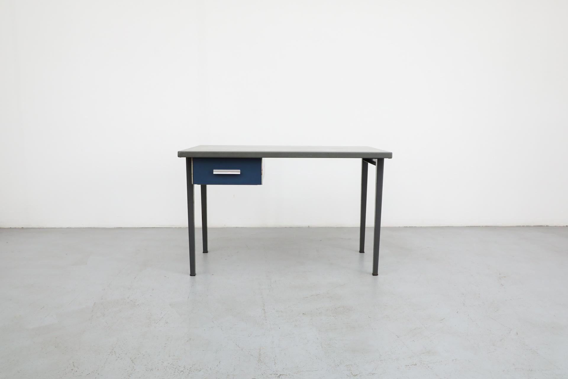 Rare Gispen industrial enameled metal desk or vanity with linoleum top and one side drawer enameled in blue with aluminum drawer pull. Cute work desk, vanity or entry table. In original condition with nice patina and wear that is consistent with its
