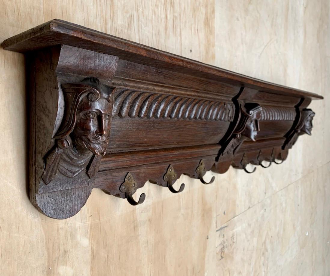 Antique oak wall coat rack with incredibly well carved head sculptures.

This marvelous antique Dutch coat rack is special, practical and highly decorative. It is special, because of the quality of the unique carvings and its excellent condition. It