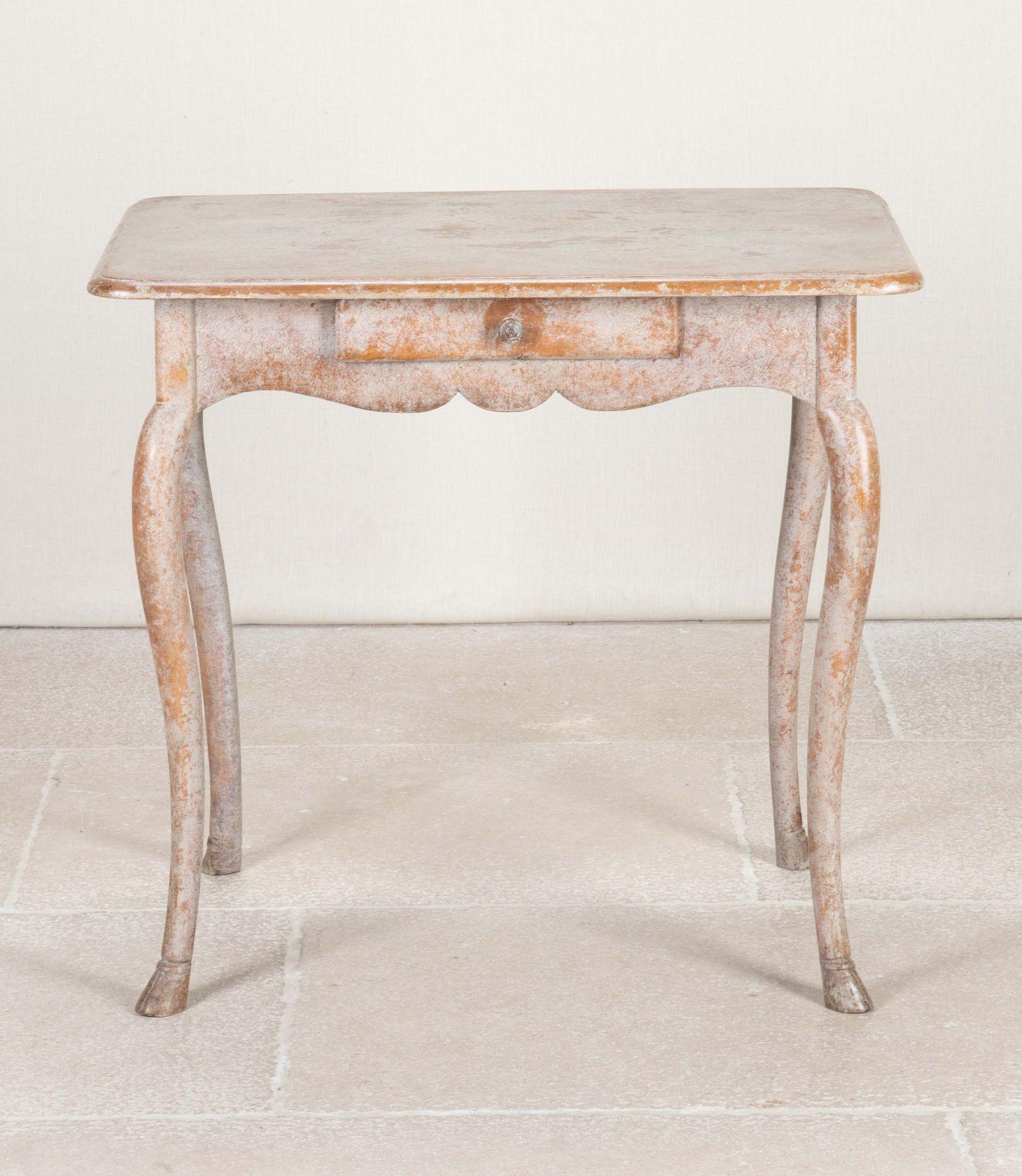A charming turn of the century, 19th Century Swedish table. 
With small drawer and scalloped detail, the shaped legs end with carved hoof feet. Later repainted.
Circa 1800.