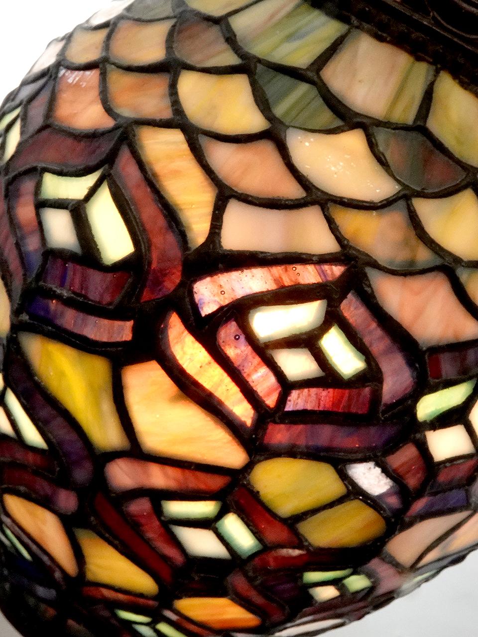 This looks as if it was a gas lamp at one time but was electrified to take a single E26 bulb. The lamp is very unique with a well done 7 inch diameter egg shaped leaded stained glass globe. It Measures 18 inches with by 25 inches tall.