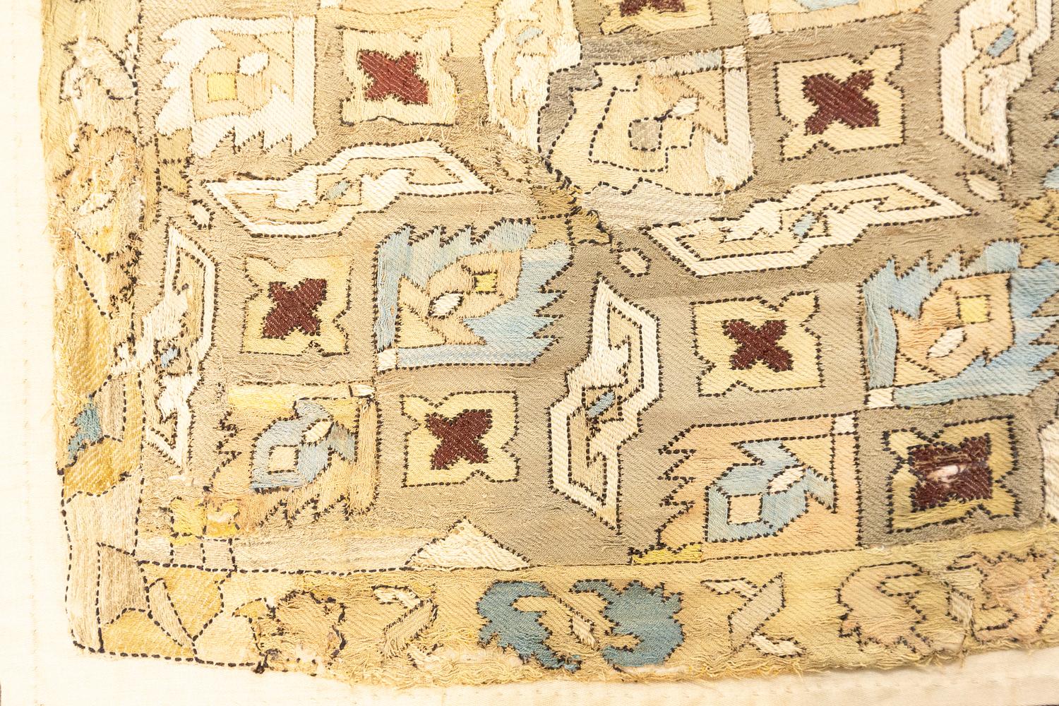 This is an antique silk Azerbaijan embroidery woven during the 18th century and measures 76 x 74CM in size. It has an all-over highly geometric floral design with muted pastel colors. It has a single border that follows the field’s color palette and
