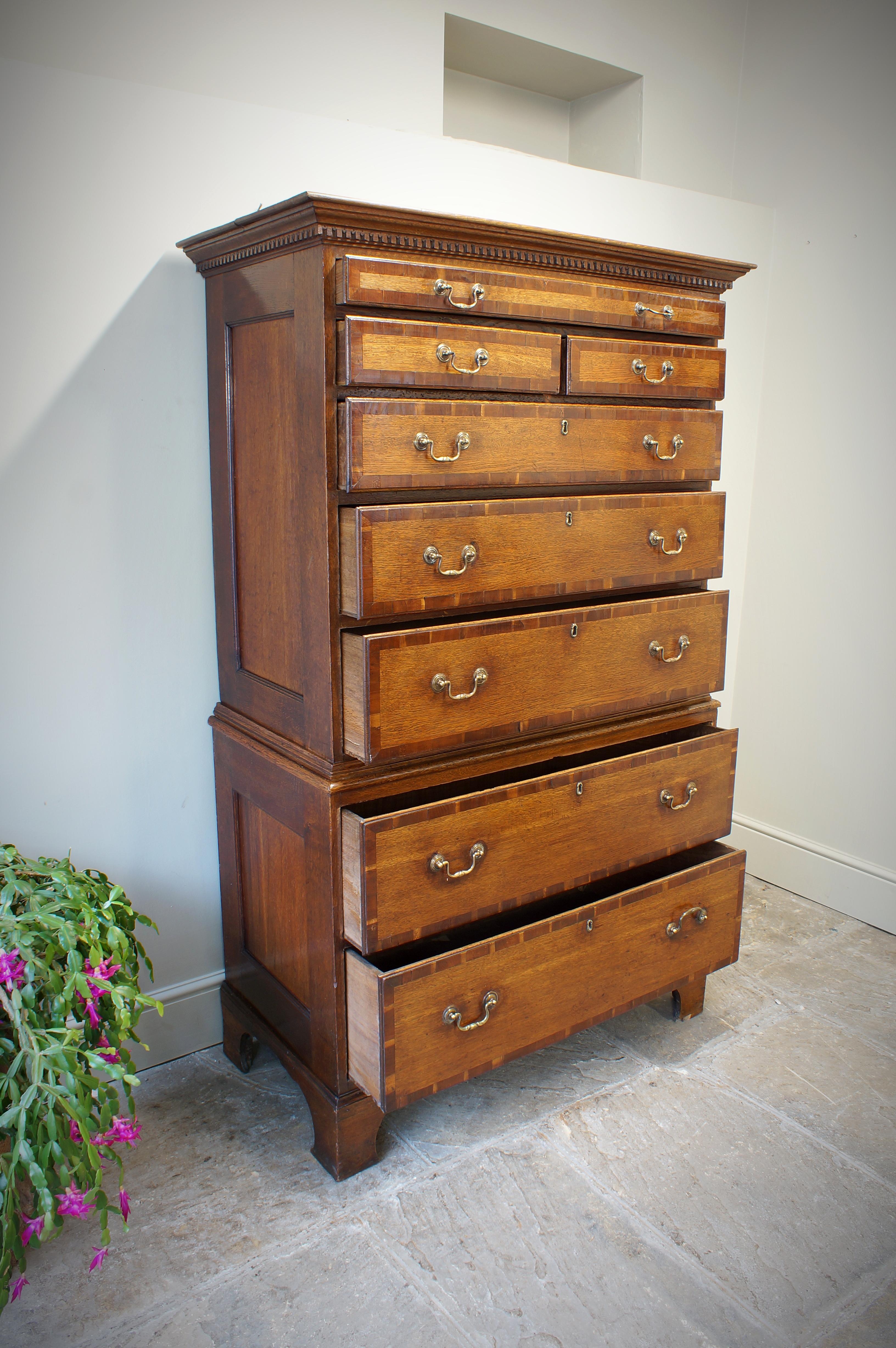 A good Oak Tallboy, or chest-on-chest of small proportions. The upper section has moulded dentil cornice, over one long, two short and three further long drawers. The base section with two more long drawers standing on bracket feet. All drawers