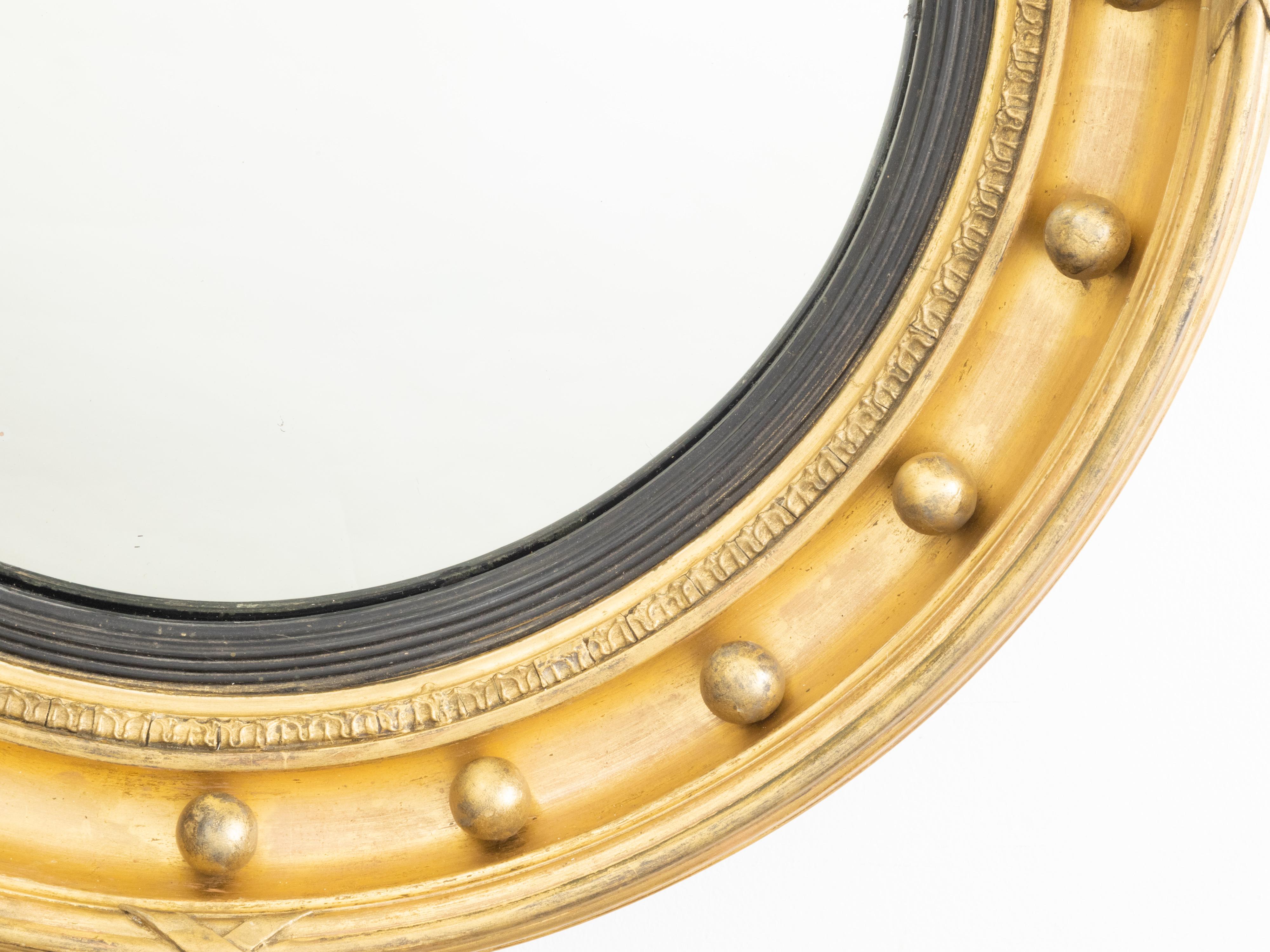 Miroir Petit miroir anglais du 19ème siècle en bois ébonisé et doré Girandole œil de bœuf