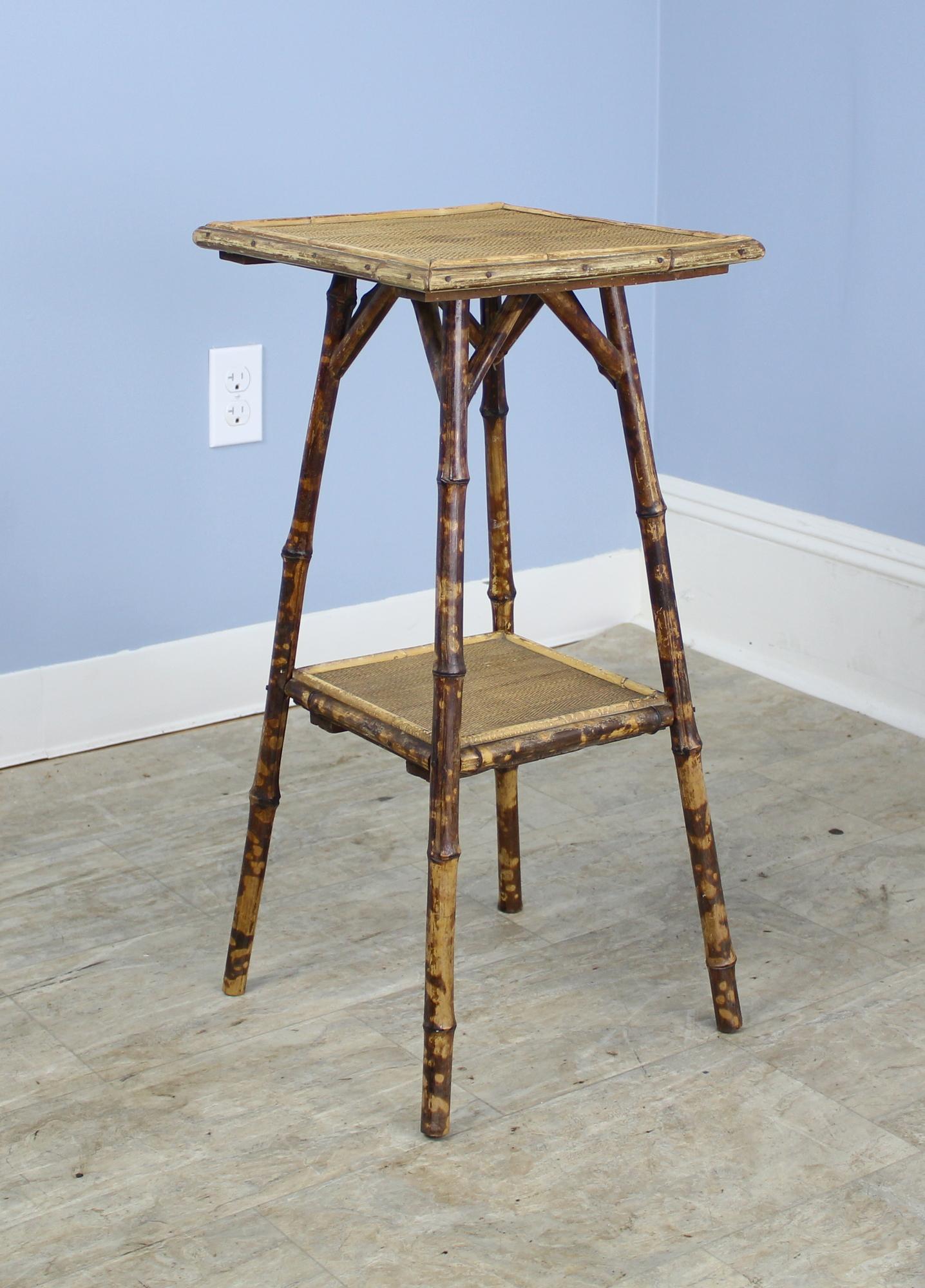 A very small bamboo side table, mildly distressed with wonderful antique color and patina. The painted legs still retain their vibrancy. Sweet!