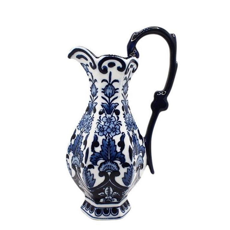 A small ceramic flow blue pitcher or vase. On a white glazed background, pretty floral designs accent the body of the vessel. This piece would make an excellent table accent or flower vase. 

Dimensions:
8.25
