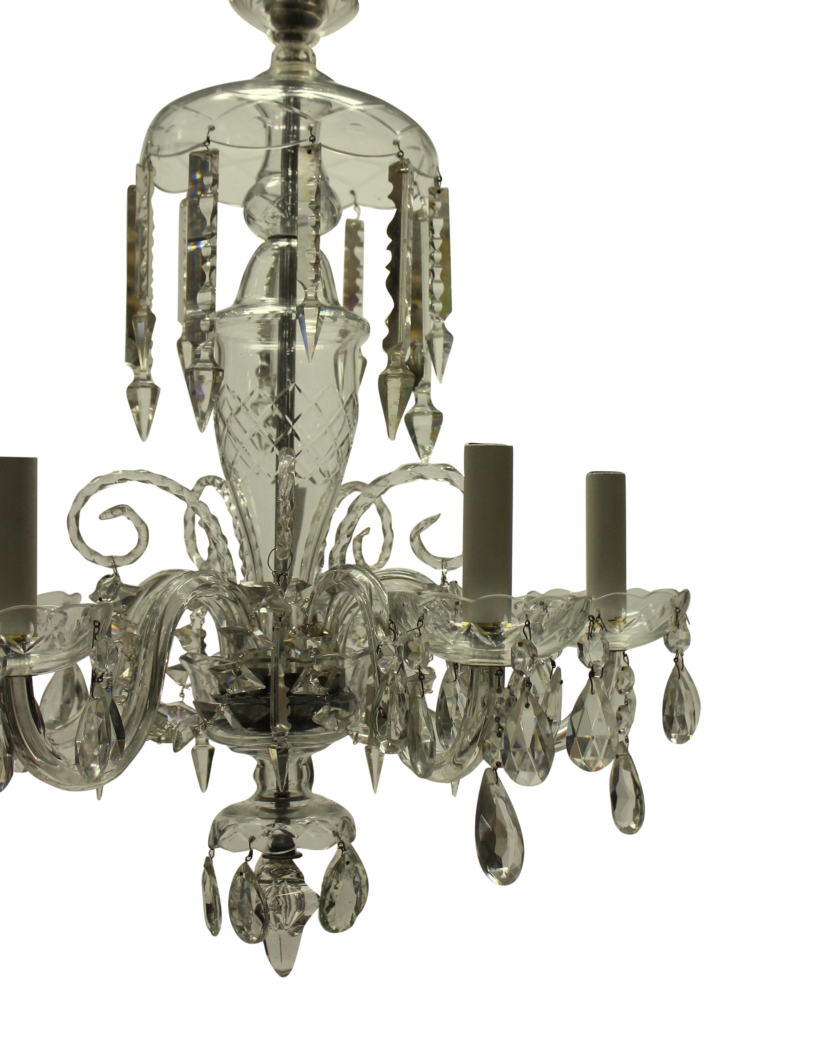 A small English cut glass chandelier of five branches, hung with cut pendants and chains.