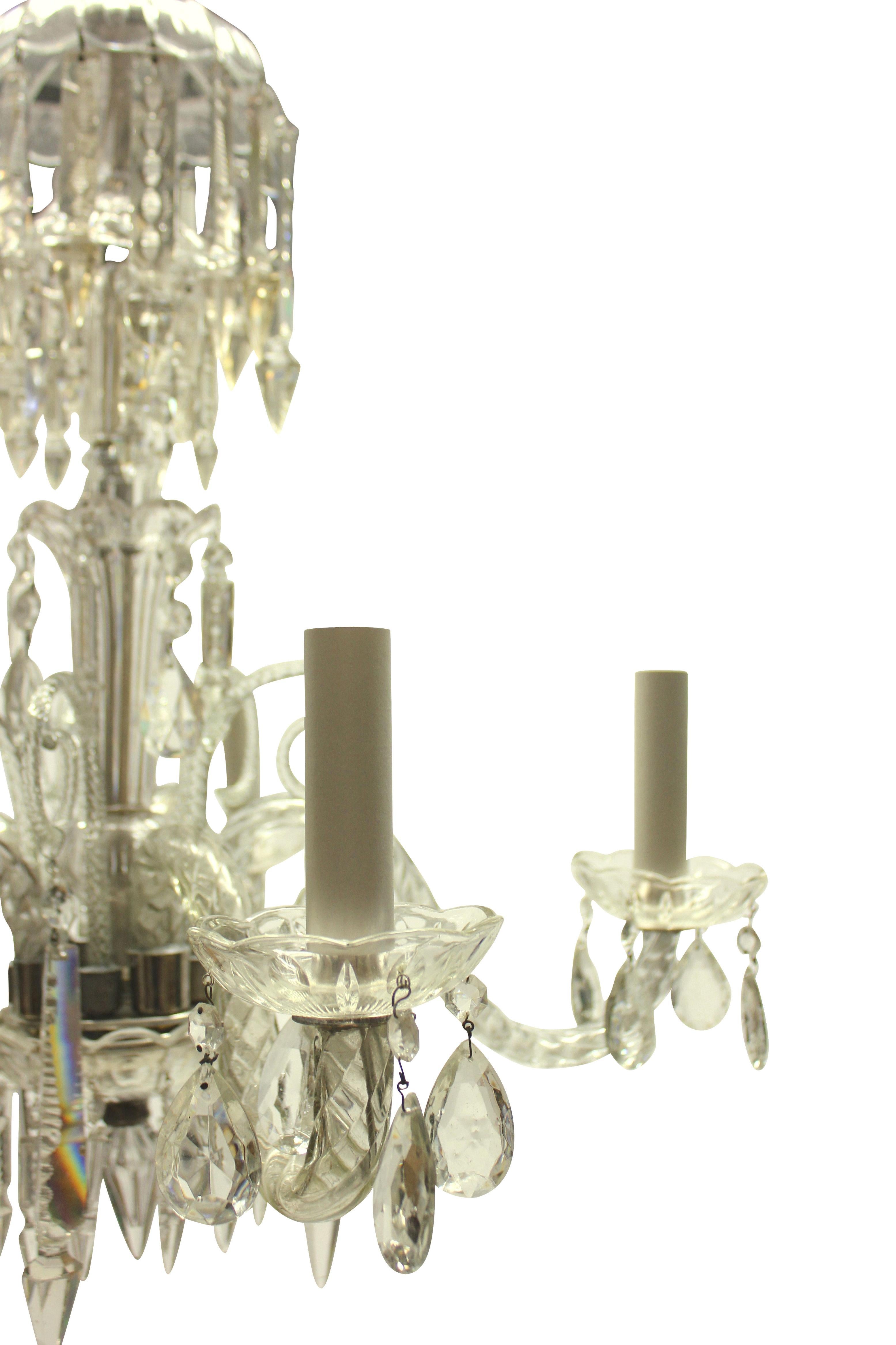 A small English cut glass chandelier of five branches, hung with cut pendants and chains.