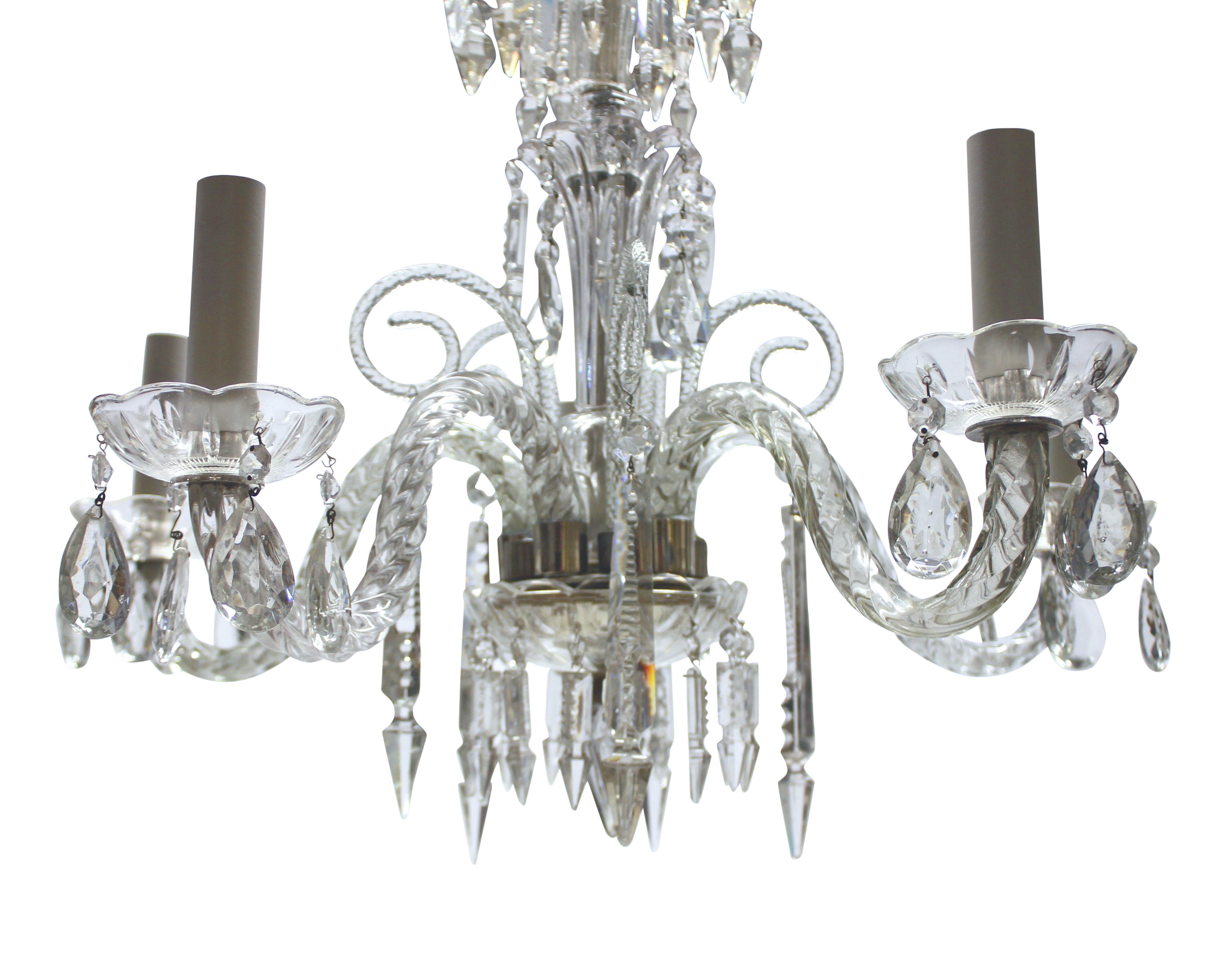 A small English cut glass chandelier of five branches, hung with cut pendants and chains.