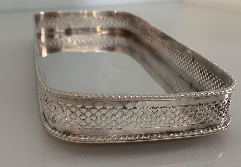A sweet and small tray with a very nice 'woven' gallery detail, the piece is wonderful for a pair of cocktails, h'orderves, to display of desk items, or a catch all for keys and mail!

The sophistication of silver with a convenient size and