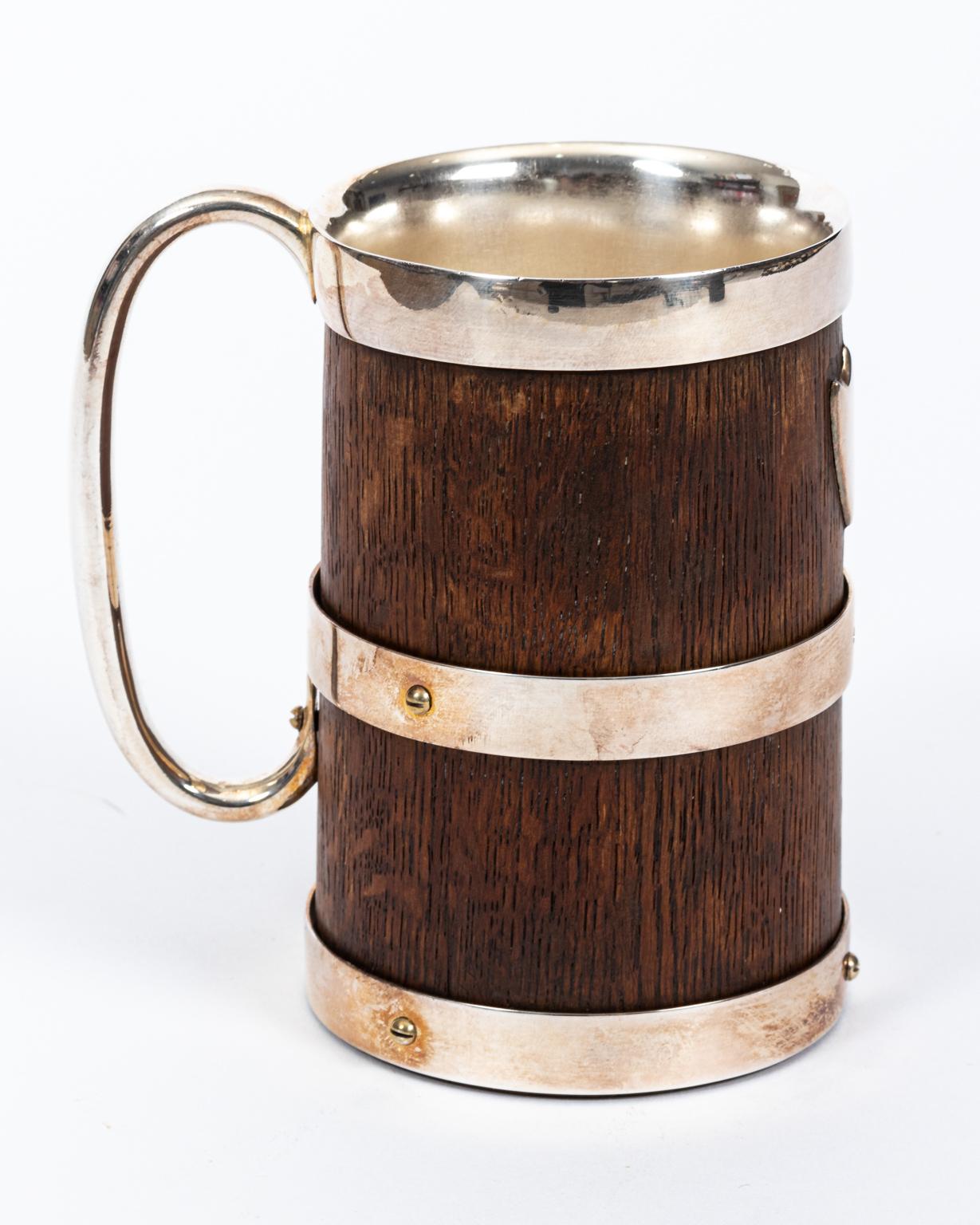 Small English wood and silver plate mug with handle and shield motif. Please note of wear consistent with age including patina and minor finish loss to the wood.