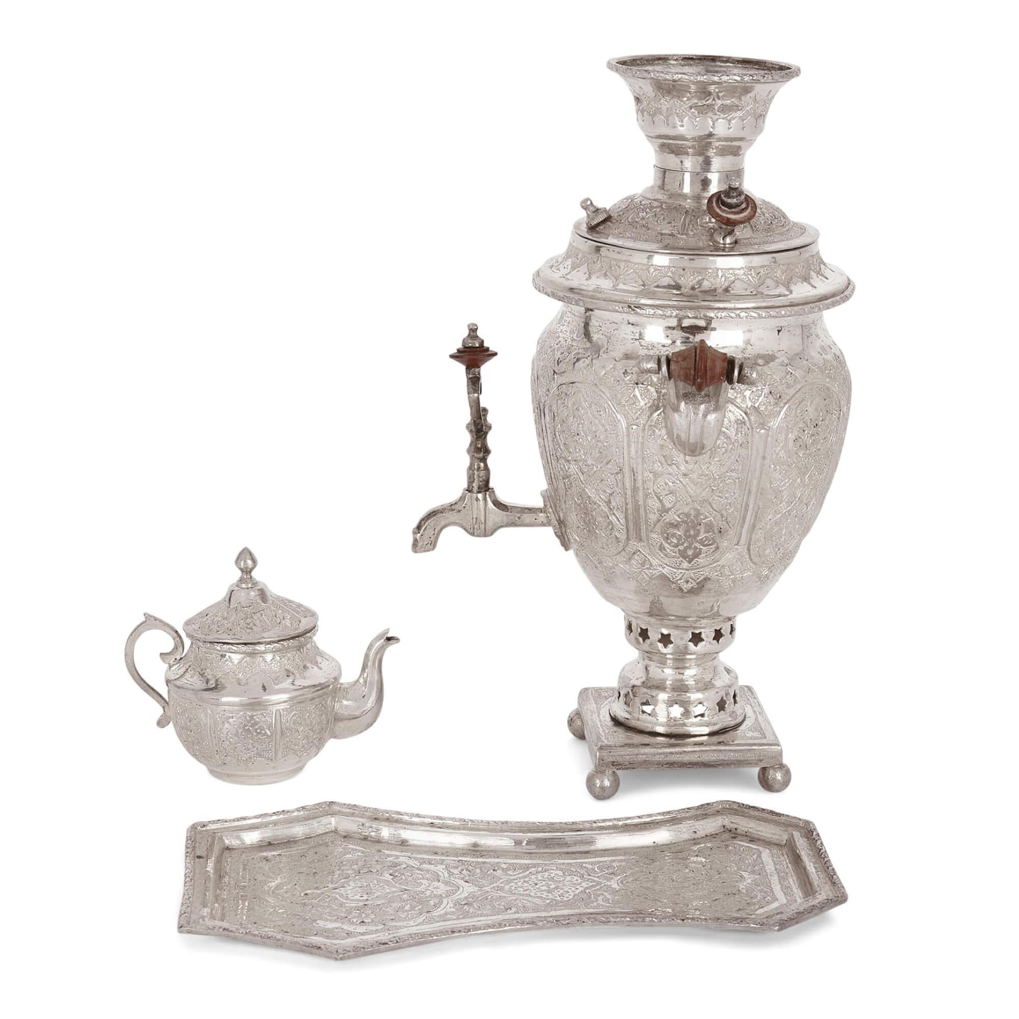 Small engraved silver part-tea service of Persian design
Persian, 20th Century
Samovar: Height 23cm, width 16cm, depth 15cm
Teapot: Height 9cm, width 10cm, depth 6.5cm

Decorated with elaborate Persian designs, this excellent tea service comprises a