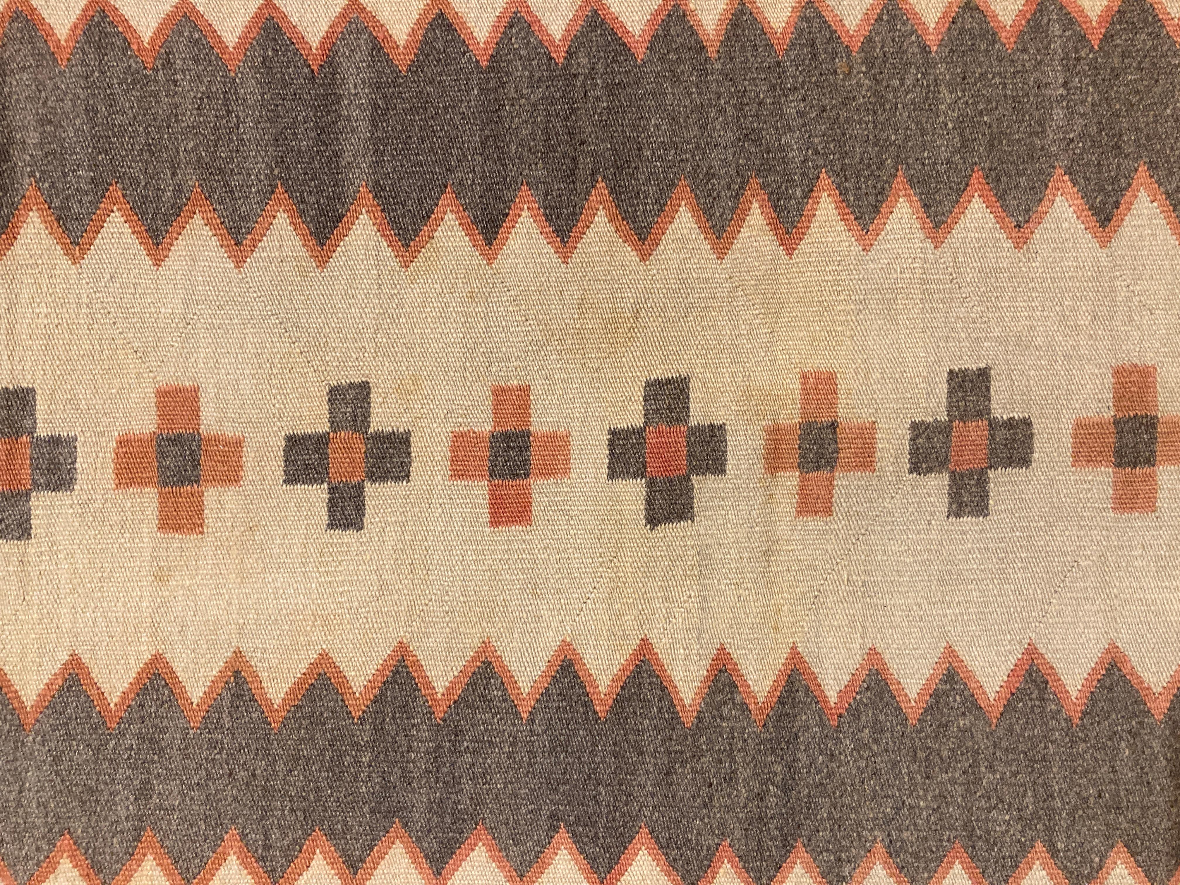 Due to the delicacy and fineness of the weave, it wouldn't be accurate to describe this as a rug. Perhaps it is a transitional Navajo piece that was woven for use as a child's wearing blanket? It is difficult to know for certain, however the beauty