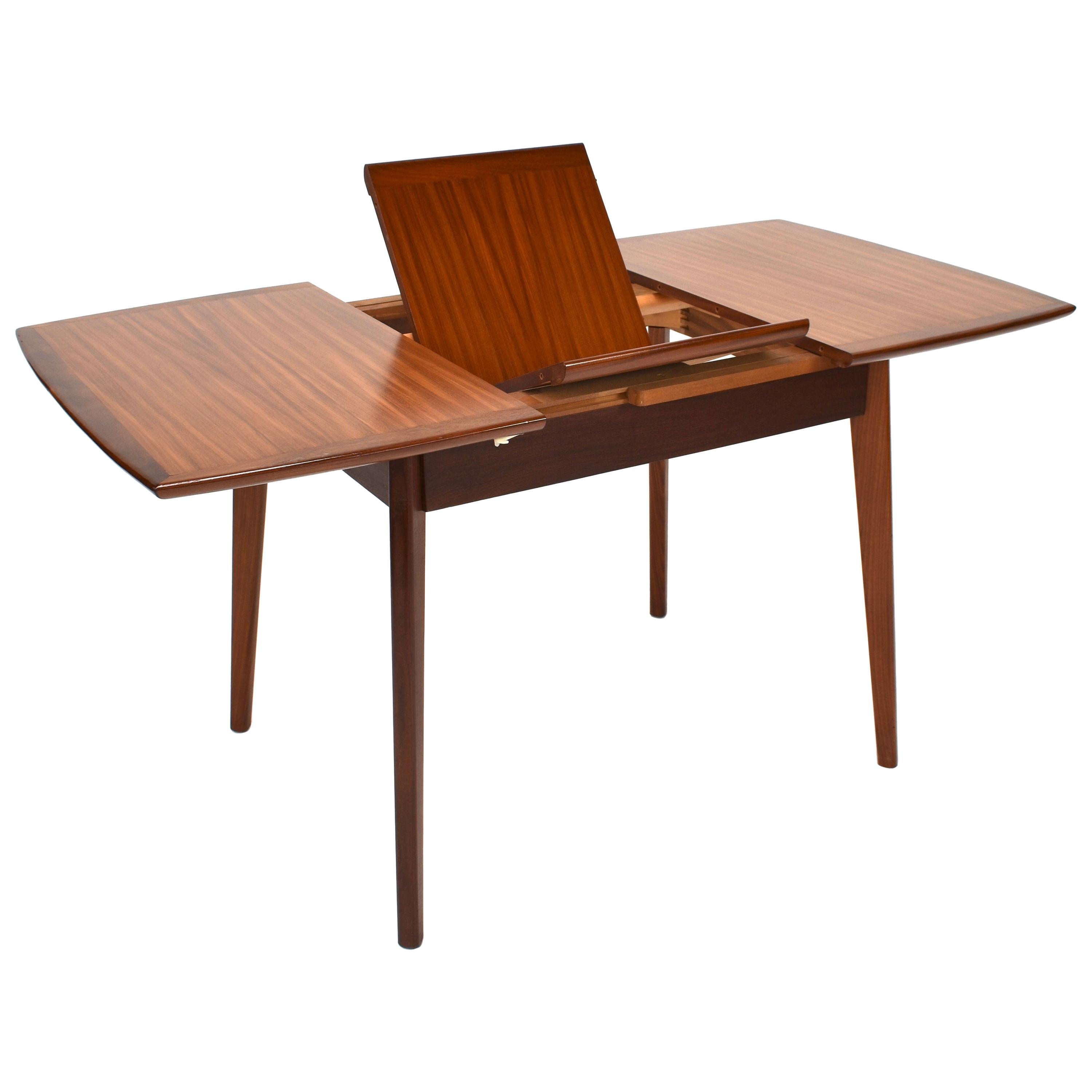 Teak fold-out dining table by Louis van Teeffelen for WeBe, Netherlands, 1960s
Teak veneer top with solid teak edges and legs.
In very good condition.
Legs can be taken of.
Minor wear on one edge (see picture)
Size in cm:
Measures: W. 100