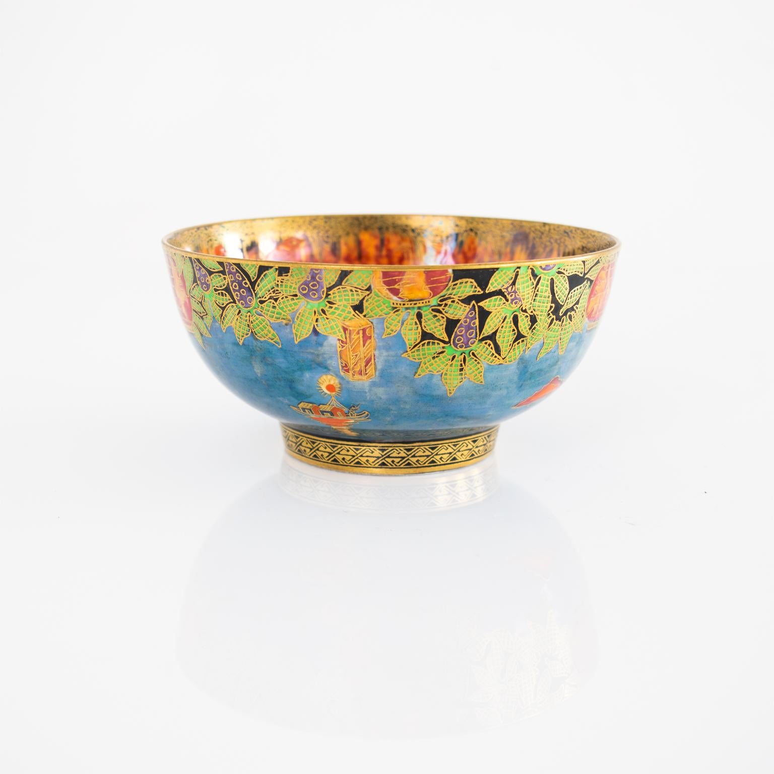 A small fairyland lustre bowl designed Daisy Makeig Jones for Wedgwood depicting a landscape on the interior, the exterior has a vine border, circa 1920s-1930s, United Kingdom.