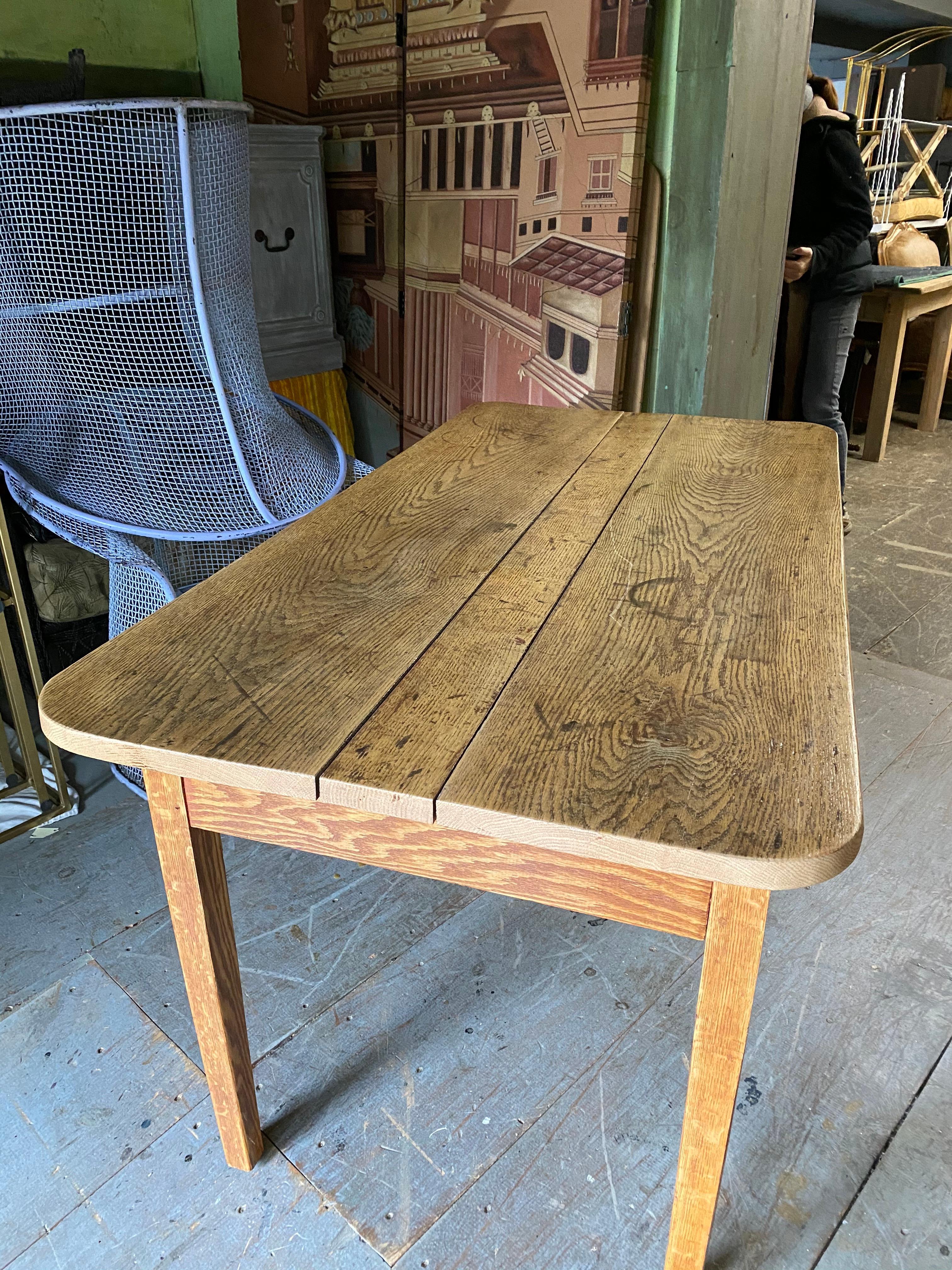 Early oak small dining, harvest table or desk. Great breakfast table in a rustic, farm, country setting or mix it up with contemporary modern industrial decor. Oak tabletop shows early wear and great patina. Top and base are a mix, earlier top and a