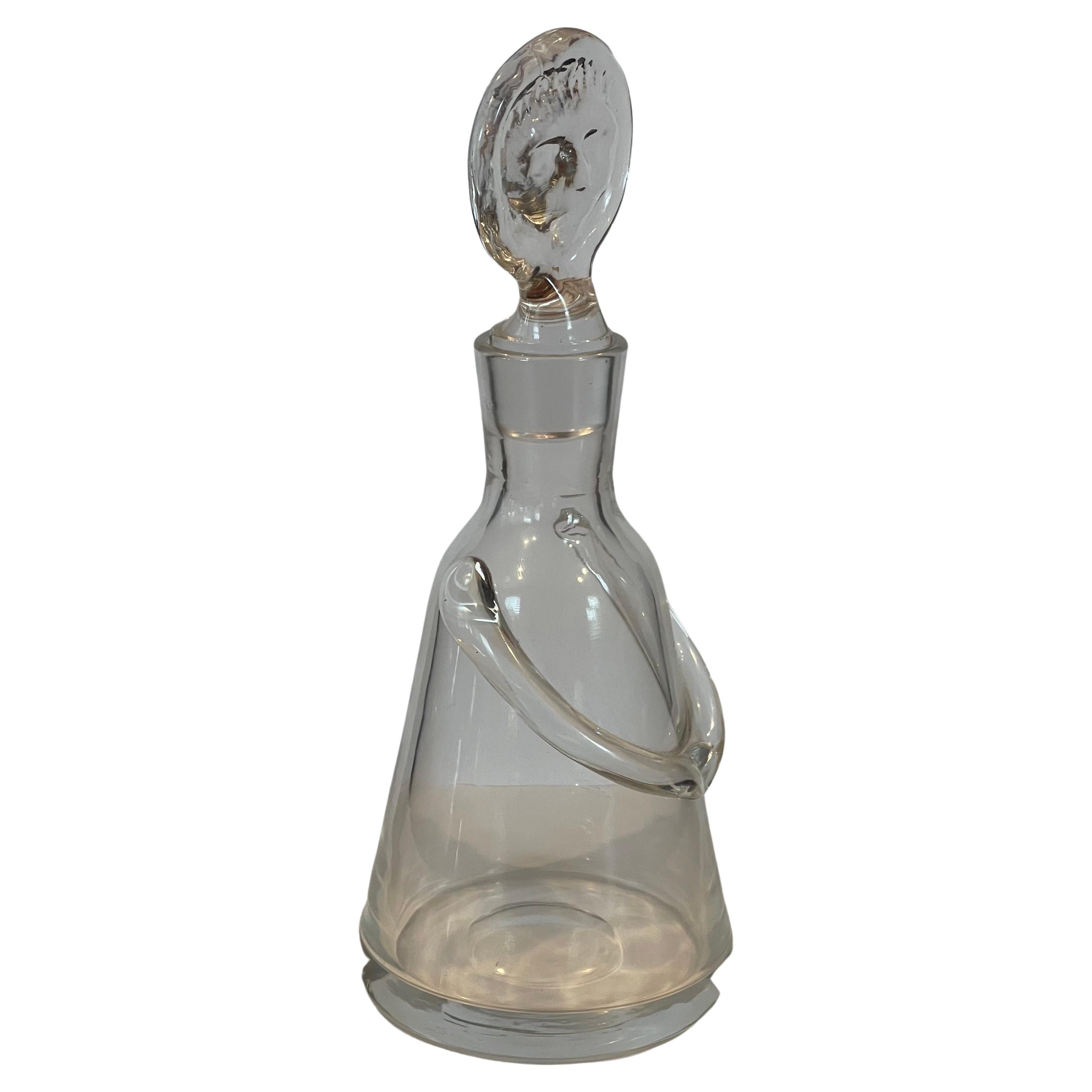 A super rare small figural glass decanter by Erik Hoglund for Boda Glassworks of Sweden, circa 1960s. The decanter is in very good condition with the exception of a small chip on the tip of the stopper (cannot see when it is inserted in bottle.) 