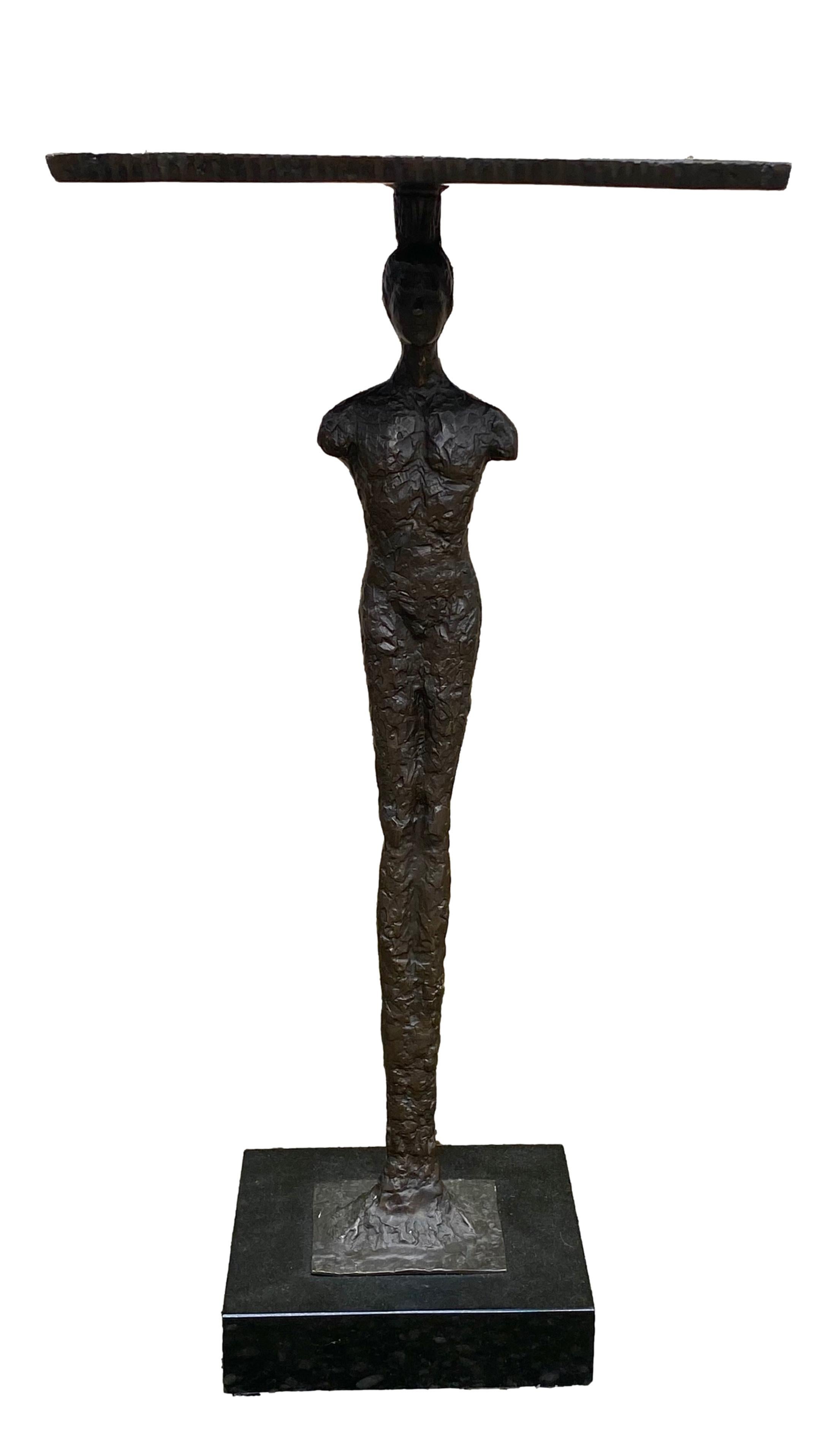 Bronze figural table with black granite base.... sculptural in the style of Giacometti.... 
