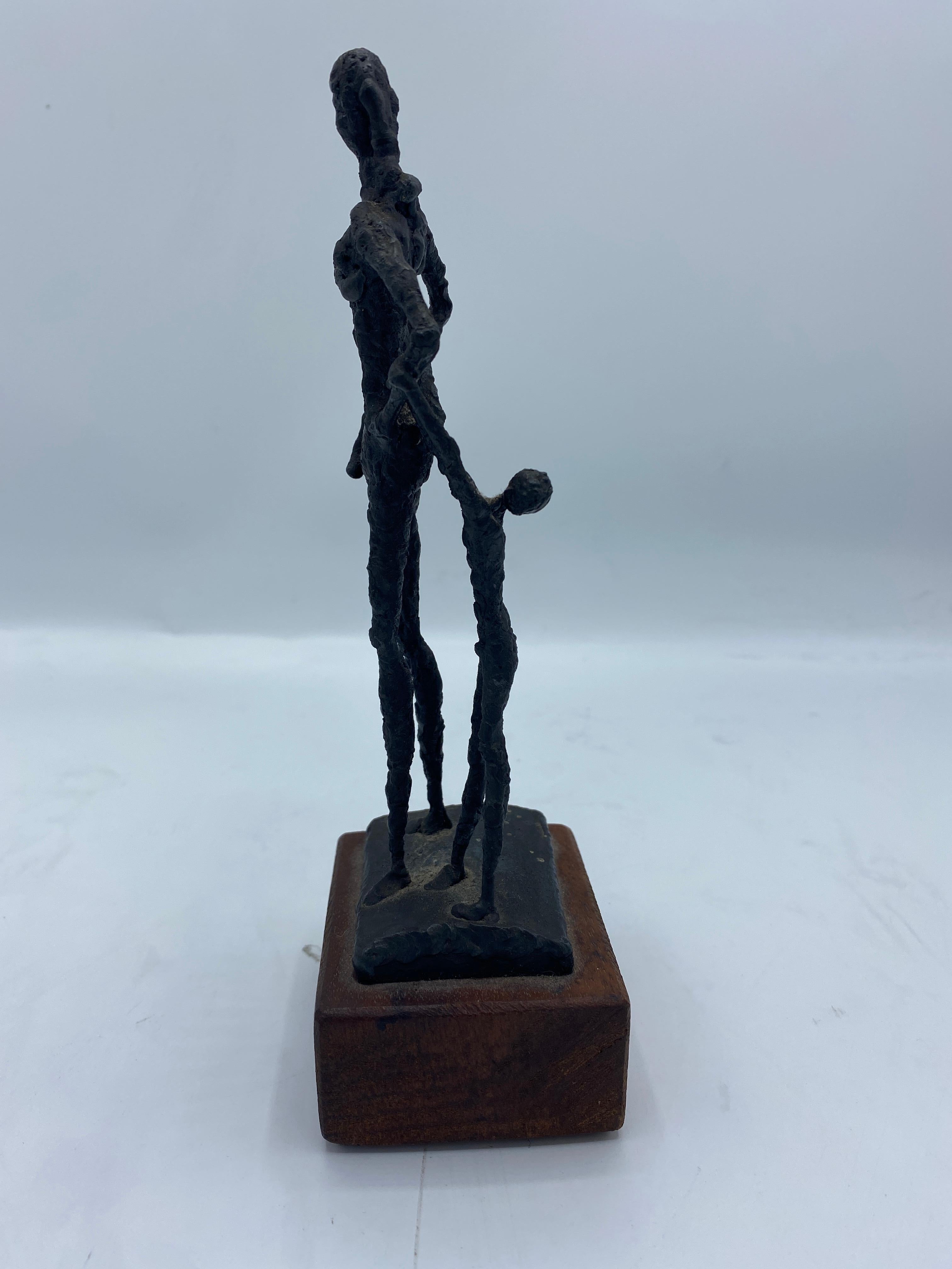 Small figurative metal mid 20th century sculpture by Harris Sorrelle
Metal tag underneath signed H. Sorrelle, dated '64' 
Measures: 8” H, 2.5” W, 2” D.