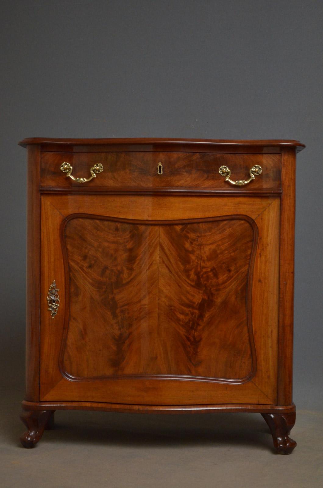 Sn4385, 19th century Continental chiffonier of diminutive proportions, having serpentine top above a drawer and paneled cupboard door enclosing a shelf, all fitted with brass handles, escutcheon and working lock with a key, standing on knurl feet.
