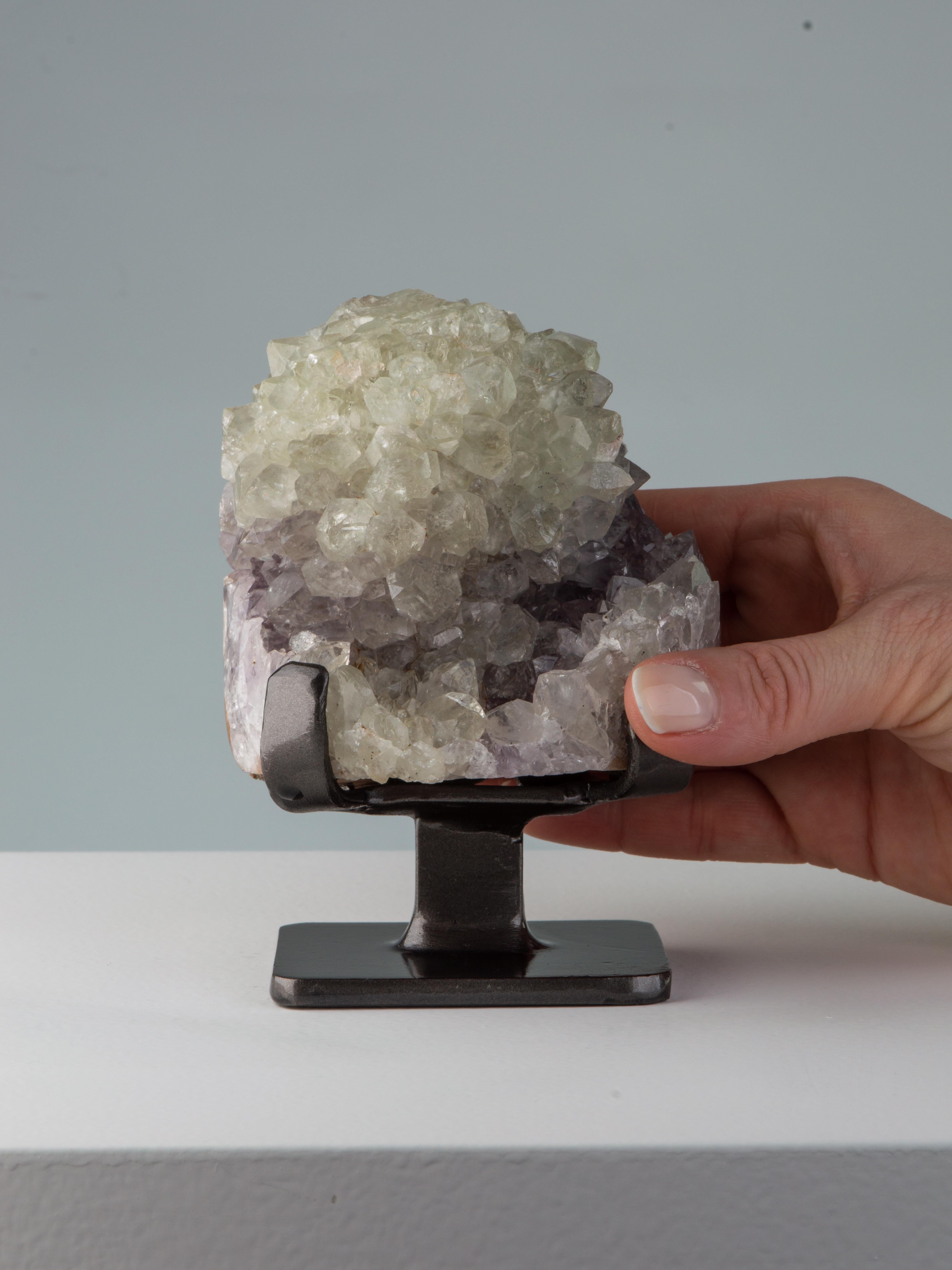 A small formation consisting of a white quartz stalactite on a bed on lilac
amethyst.

This piece was legally and ethically sourced directly in the prestigious mines of Uruguay, South America. Uruguayan amethyst is internationally recognised as