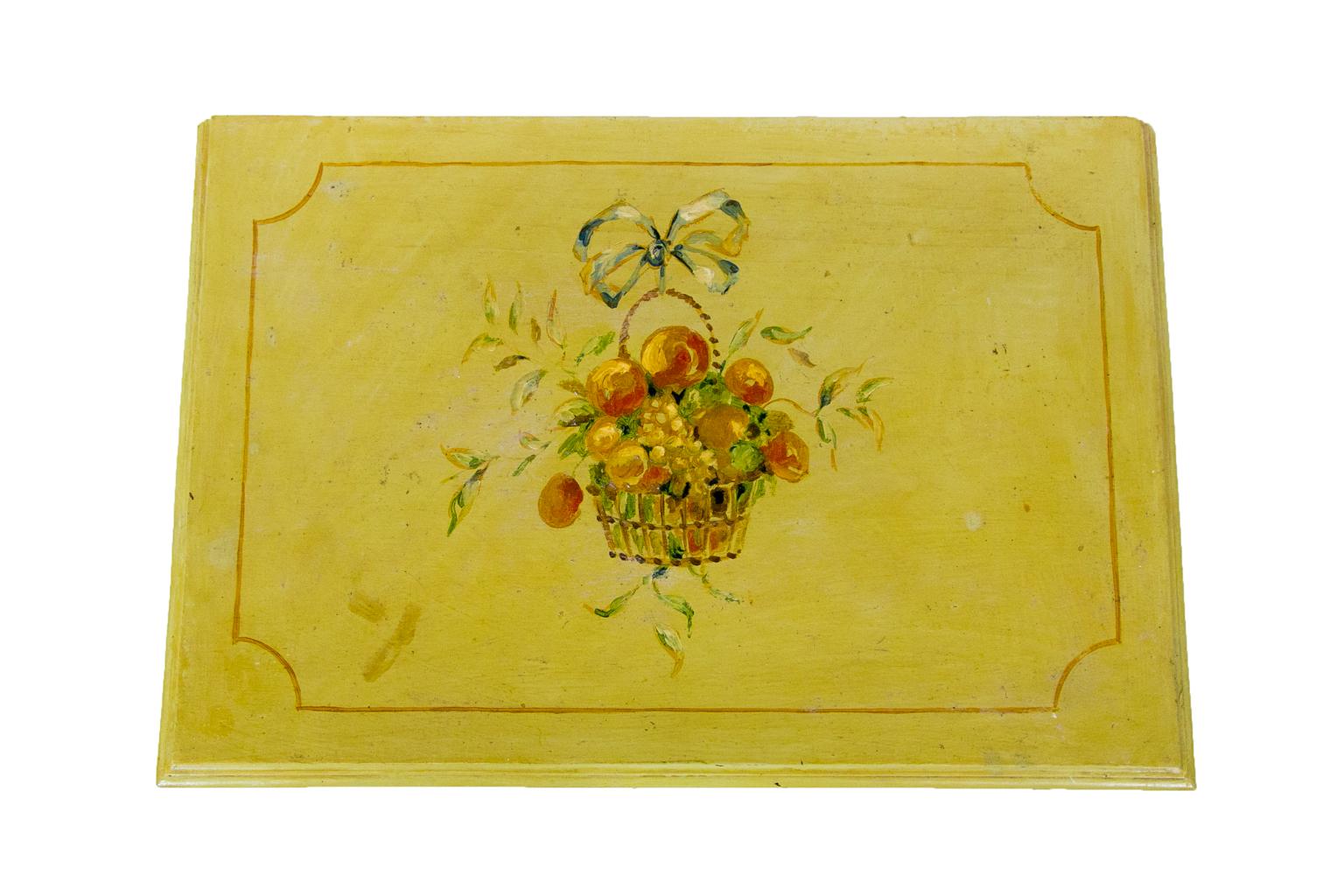 Small floral painted chest is painted with floral and ribbon motifs.
  