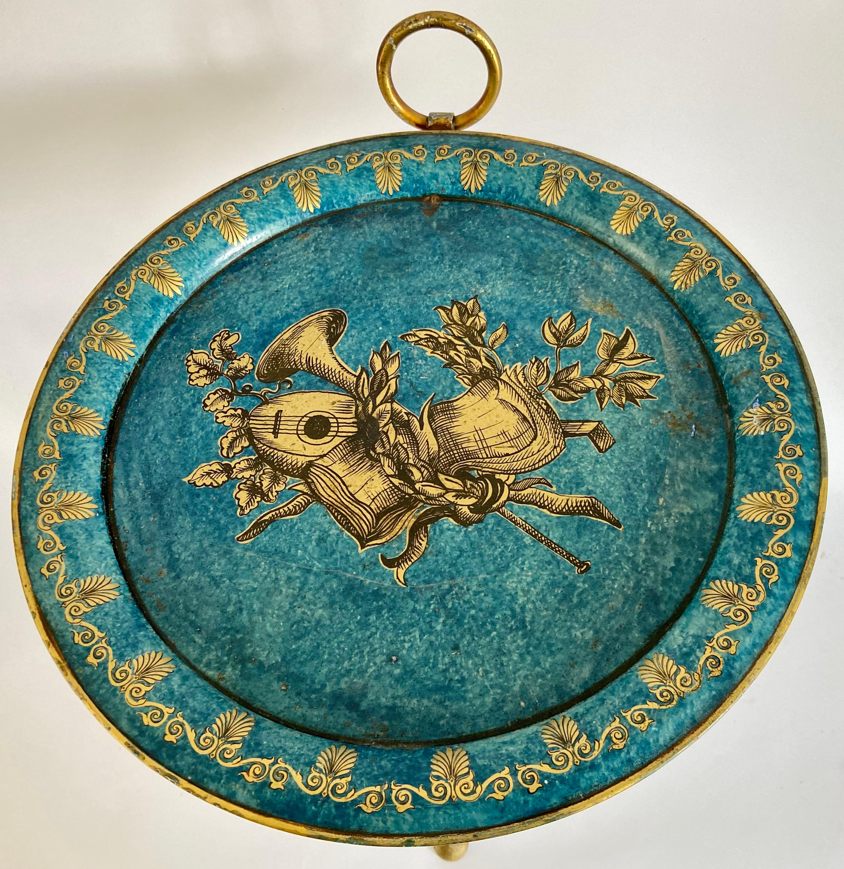 Small Italian Neoclassical tole metal folding side table in blue and gold
The top is decorated with musical instruments, sheet music, various leaves and a laurel wreath. Palmette leaves decorate the border. Hand-painted, circa 1960.