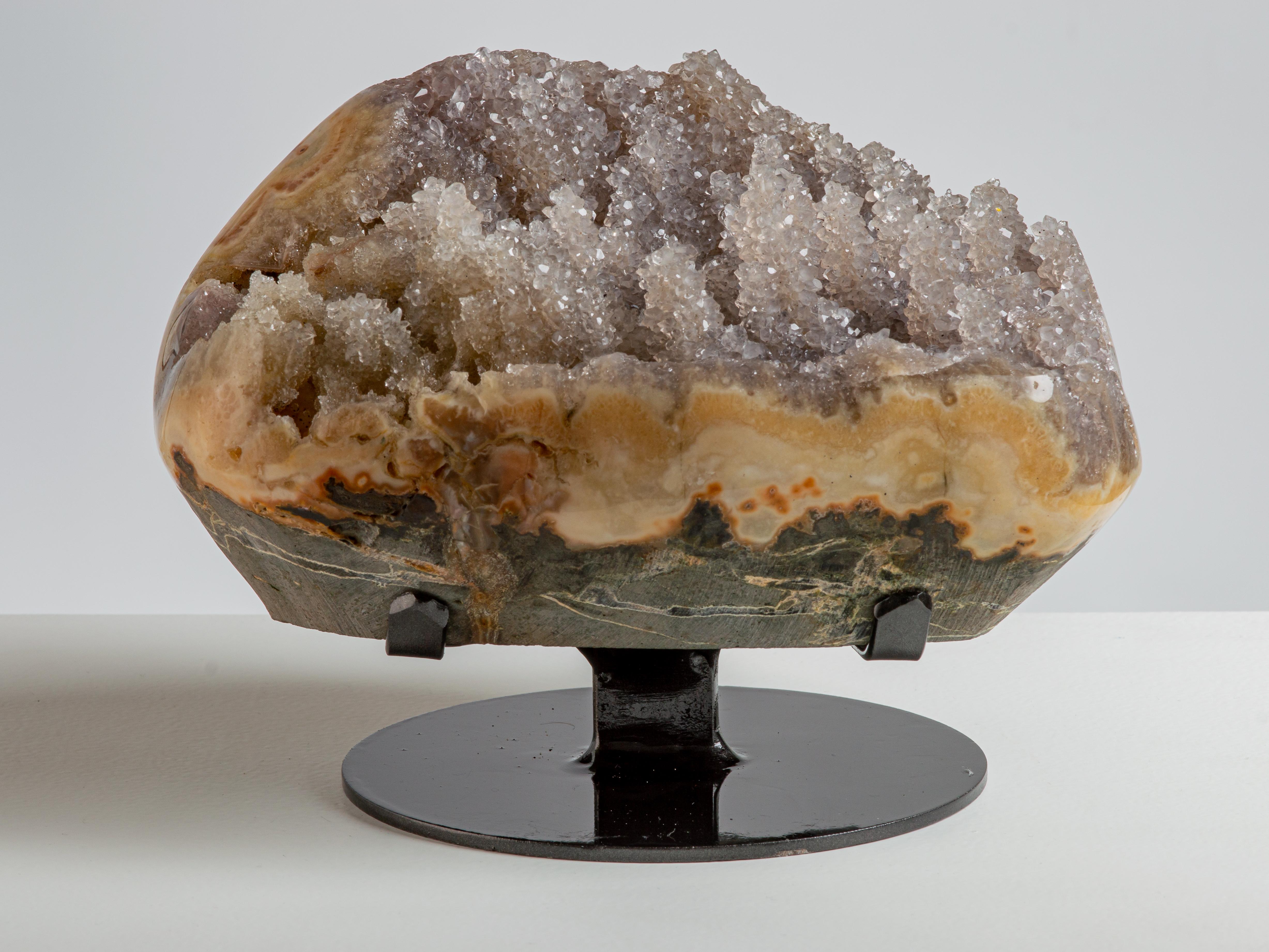 Several small stalactites adorn this piece, covered in light orange druzy quartz.

This piece was legally and ethically sourced directly in the prestigious mines of Uruguay, South America. Uruguayan amethyst is internationally recognized as being