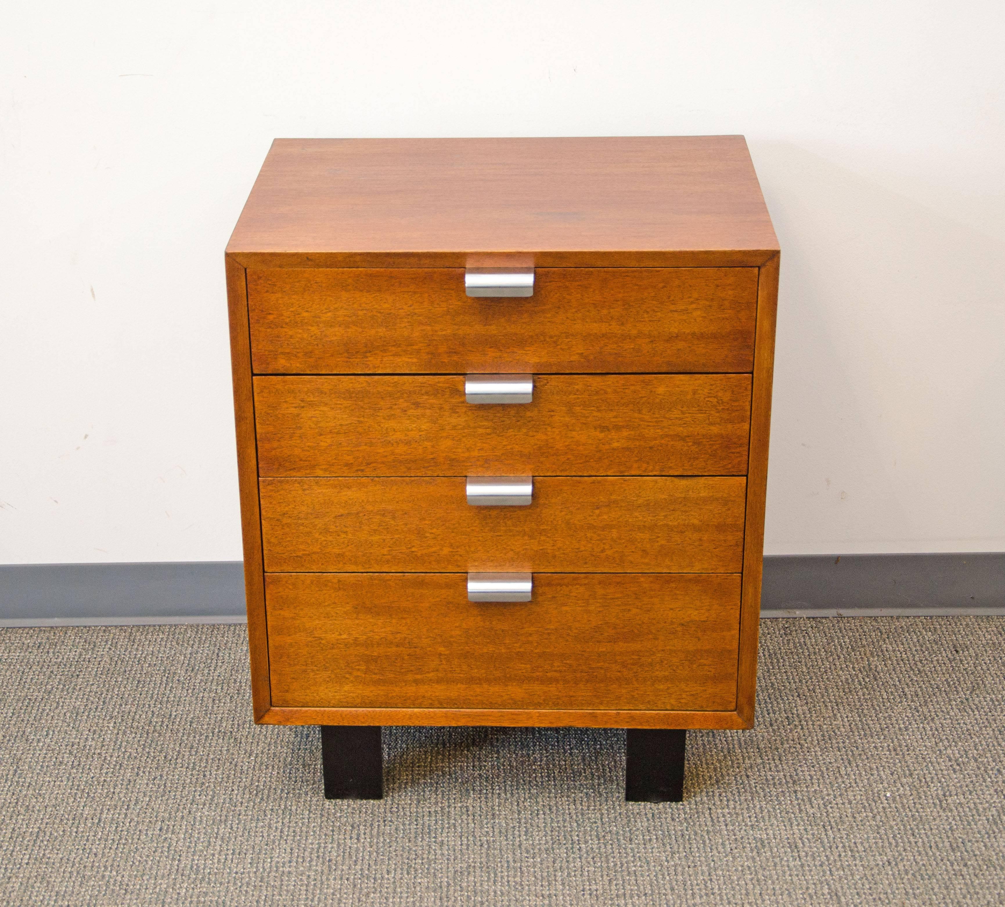 Versatile small cabinet with four drawers accented by the iconic 