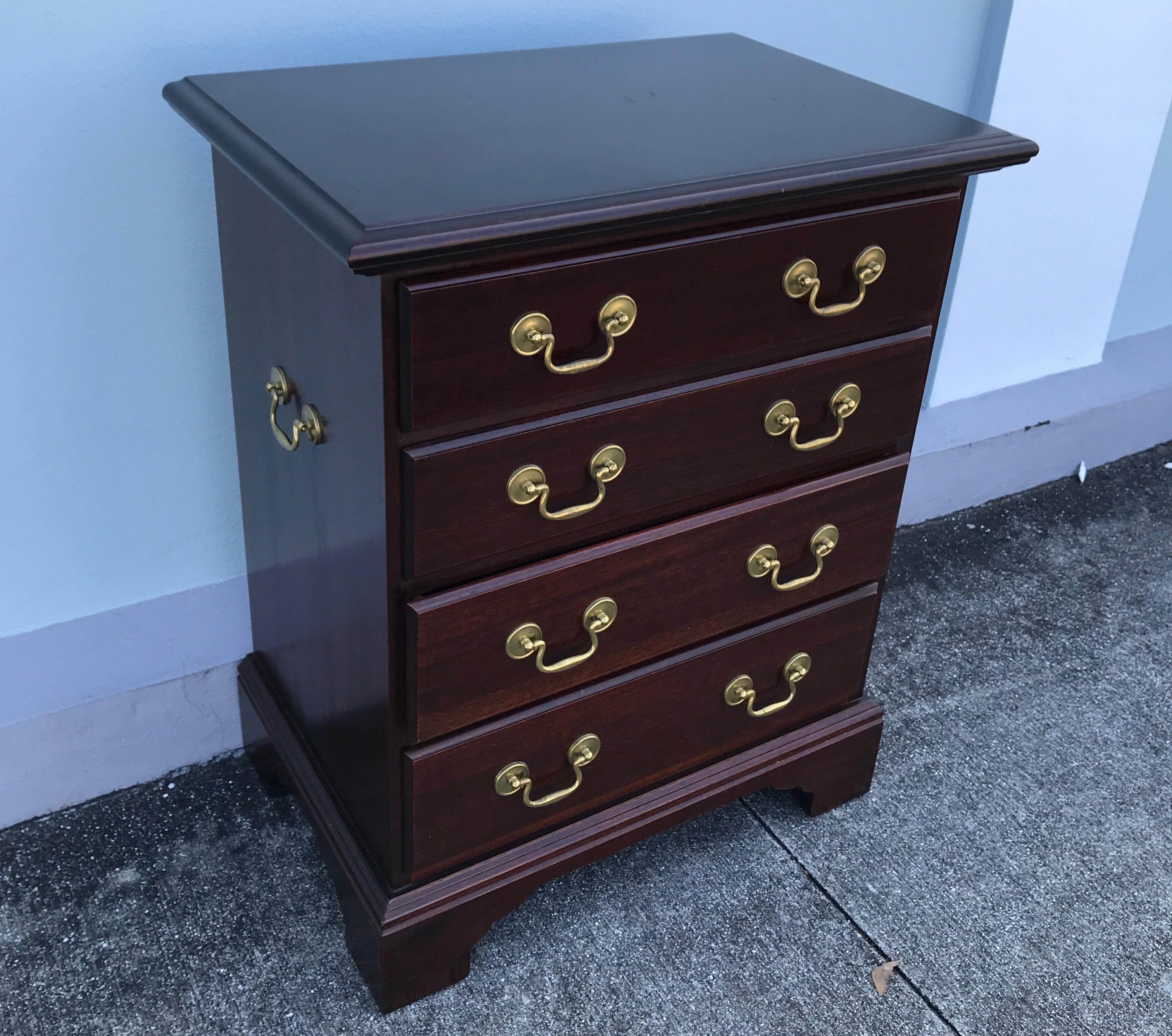 Small four-drawer chest with brass pulls. Great for a side table or nightstand.