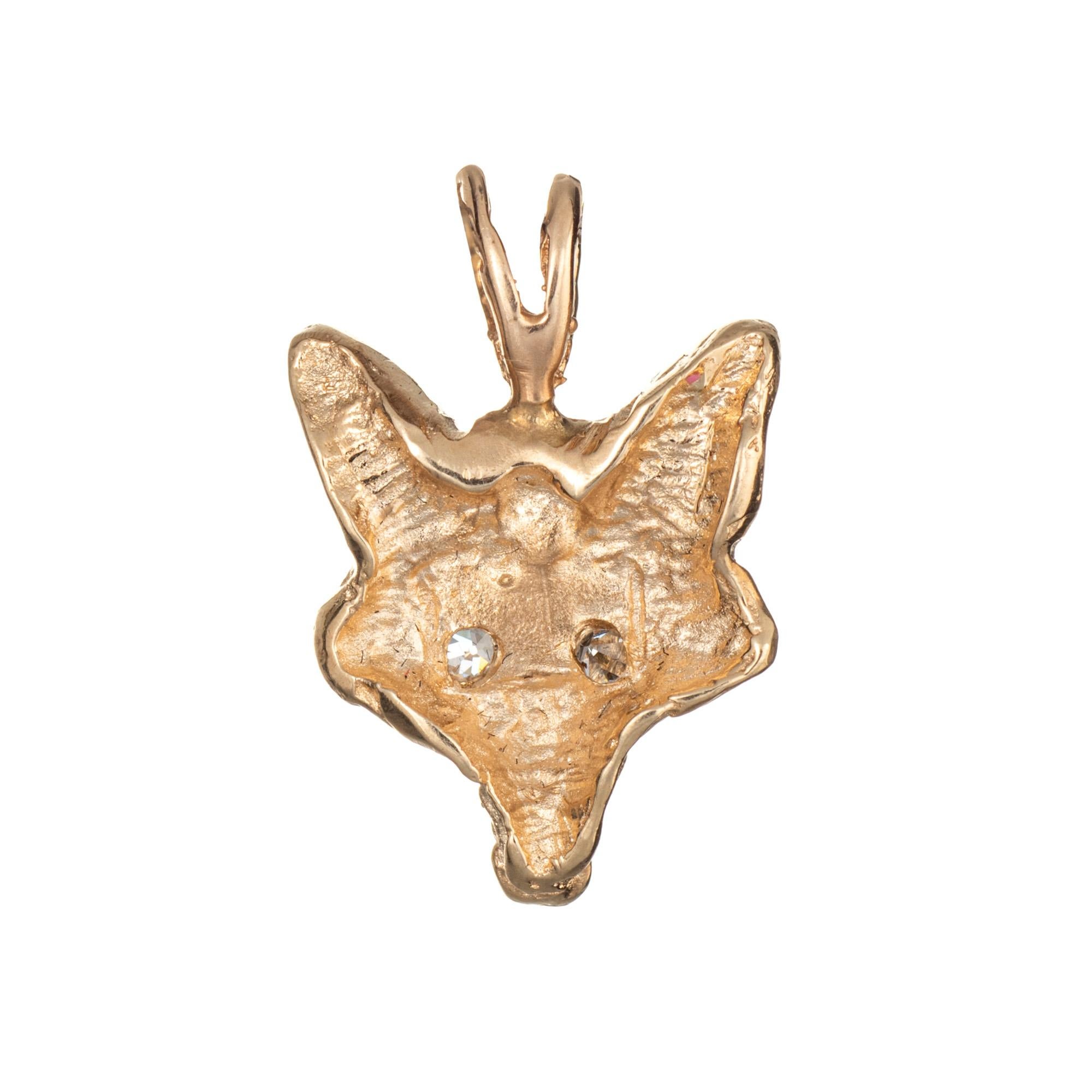 Finely detailed vintage Fox pendant (or charm) crafted in 14k yellow gold.  

Two estimated 0.01 carat single cut diamonds are set into the eyes (estimated at H-I color and VS2 clarity).

The nicely detailed pendant is small in scale and features