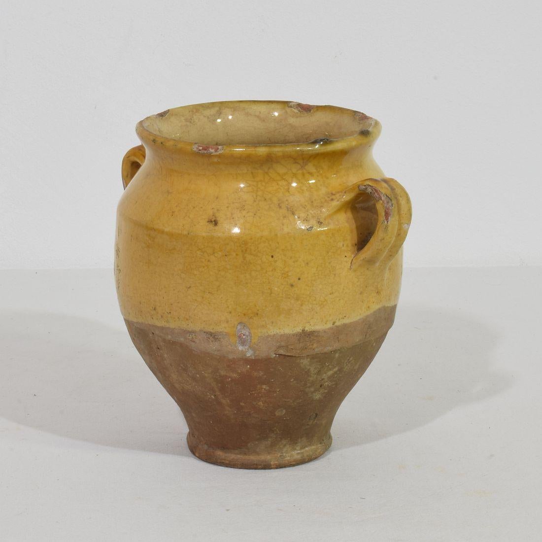 Beautiful small confit jar with its characteristic yellow glaze. 
Confit jars were used primarily in the South of France for the preservation of meats such as duck or goose for dishes such as cassoulet or foie gras. The bottom halves were left