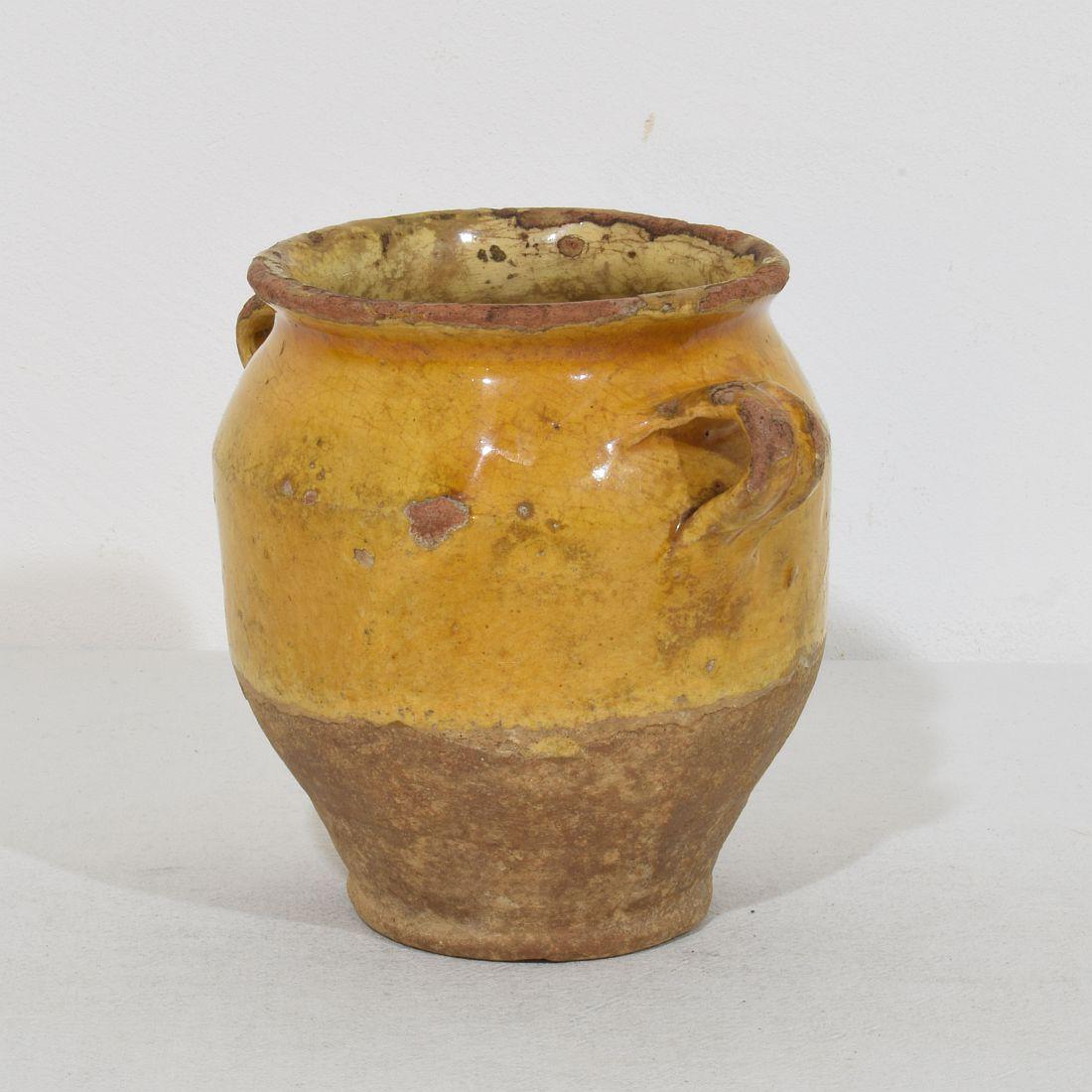 Beautiful small confit jar with its characteristic yellow glaze. 
Confit jars were used primarily in the South of France for the preservation of meats such as duck or goose for dishes such as cassoulet or foie gras. The bottom halves were left