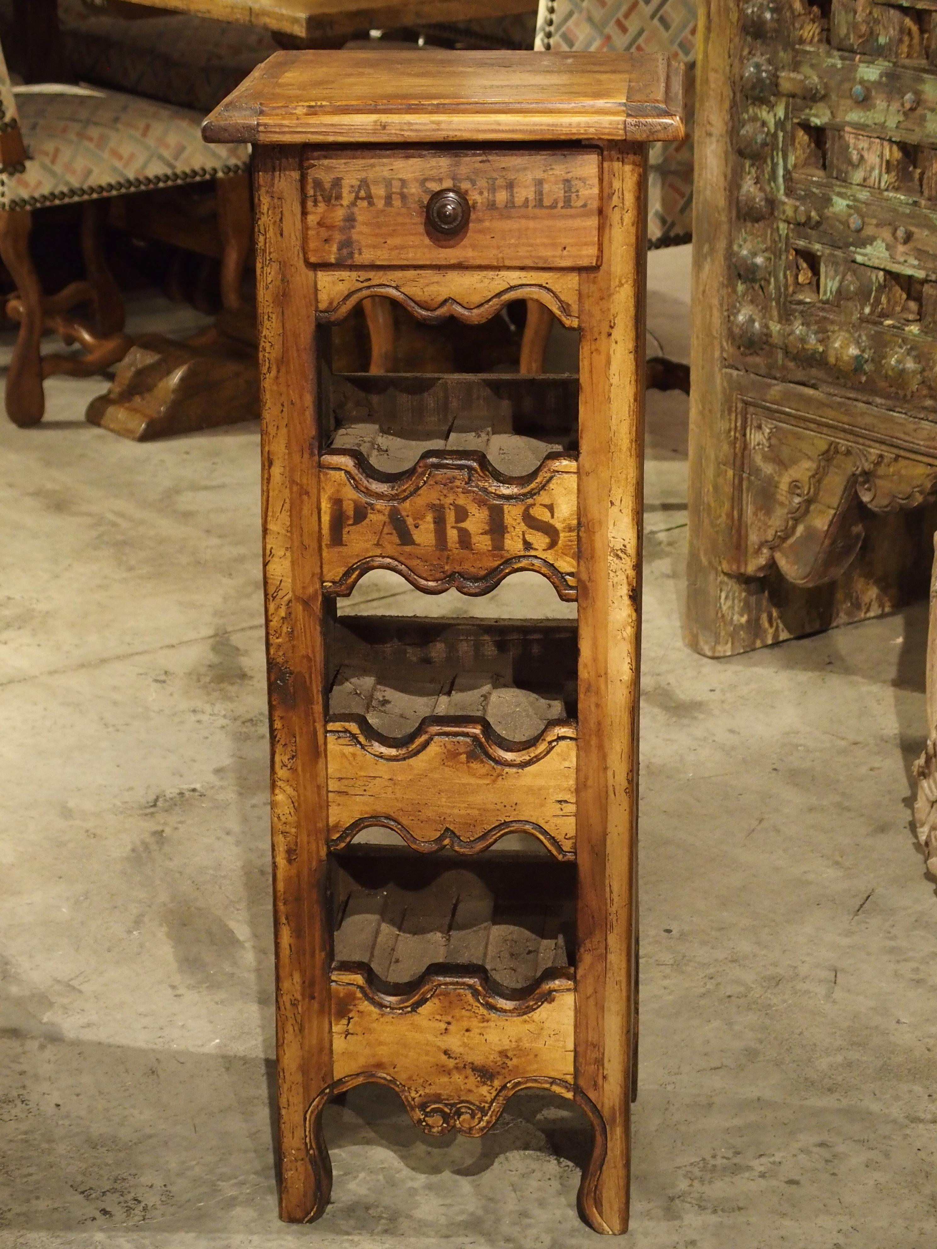 This charming wine holder has been made from salvaged antique boards in France. There is a drawer at the top with Marseille in block letters on its front and Paris in block letters on the top wine rack piece. Perfect for the wine room, den, kitchen