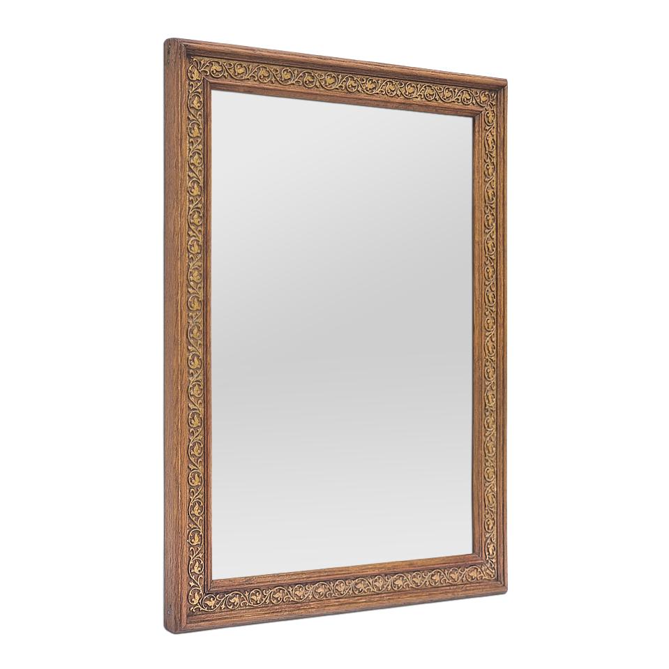 Small French antique mirror in carved light oak with gilded stucco foliage scrolls, circa 1930. Antique Frame width: 3.5 cm / 1.37 in. Modern glass mirror. Wood back.