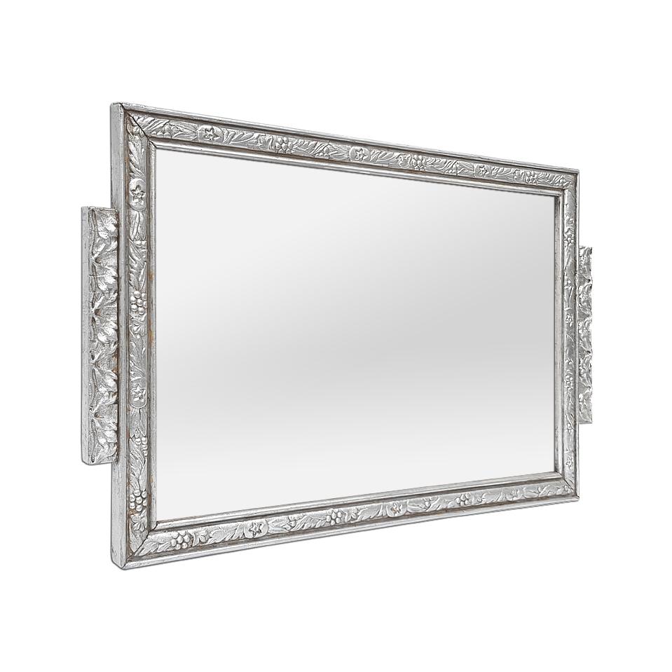 Small French Art Nouveau style silvered patina wall mirror, circa 1900.  Decorated with stylized flowers and leaves in the Art Nouveau style. Antique frame re-silvered with leaf. Frame width: 2.5 cm / 0.98 in. Modern glass mirror. Wood back.