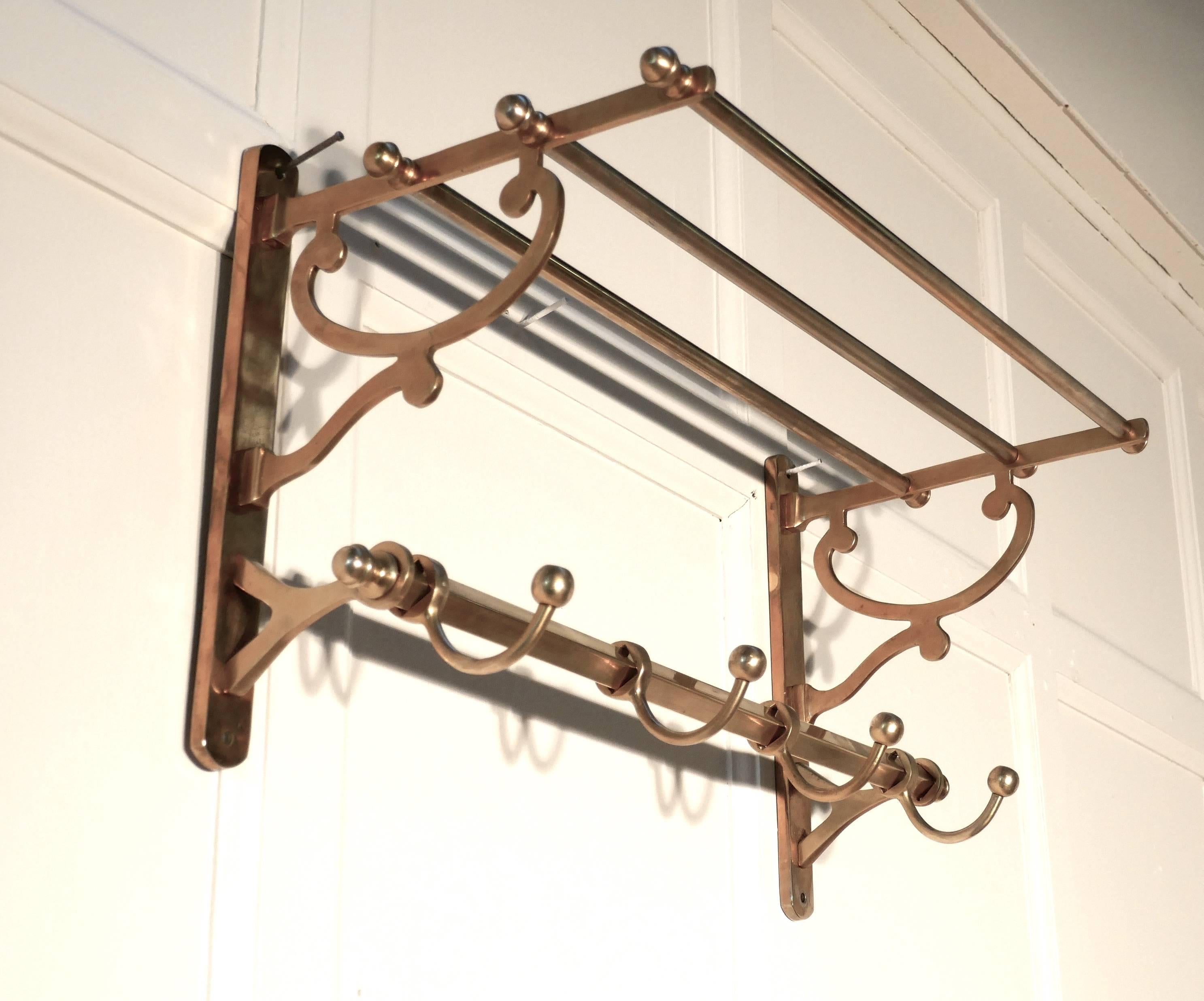 Small French Art Deco brass hat and coat rack, Pullman Railway train style

 This Art Deco style hat and coat rack has three sliding hooks and an upper railed shelf 
Racks just like these were used on French railway trains just like the ones on