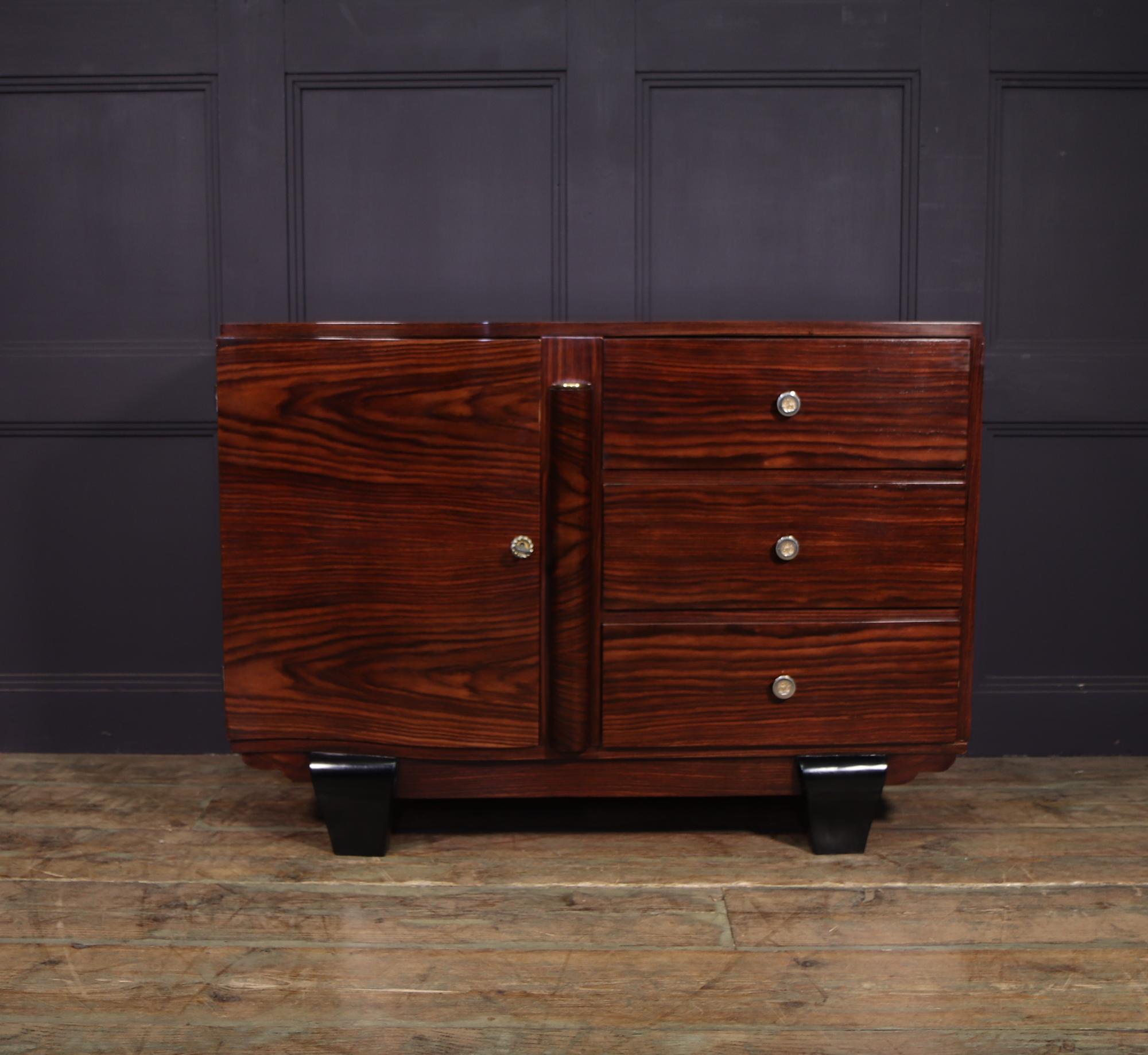 A small sideboard with single lockable door and three drawers in macassar ebony the sideboard is in excellent condition throughout and has bee restored where necessary and fully polished by hand

Age: 1930

Style: Art Deco

Material: Macassar