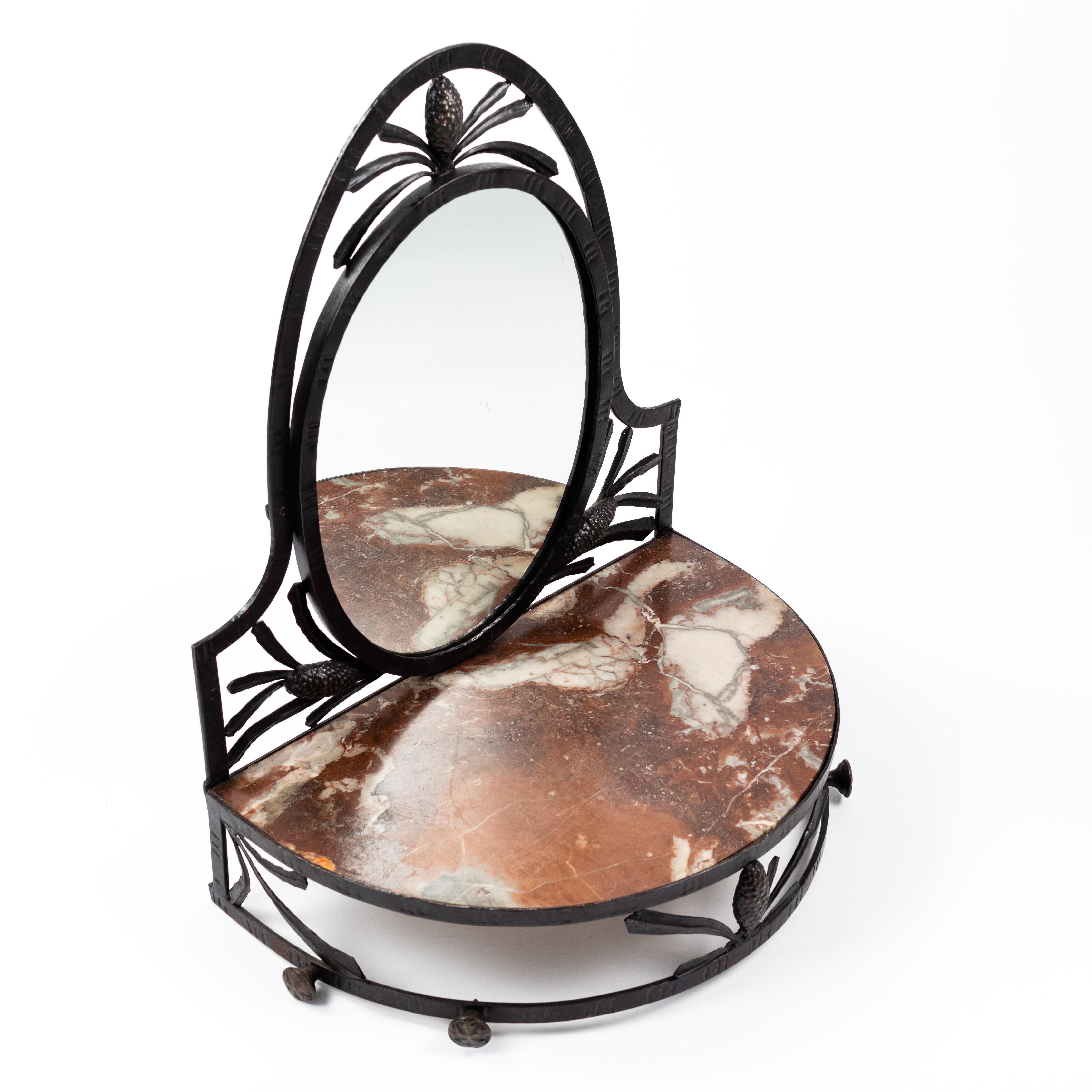 Rare and small French Art Deco wrought iron wall console with mirror. 
The frame has floral elements such as cones and stylized leaves. The table top is made of brown-red-white marble with gray inclusions.
The shapes are rounded and therefore very