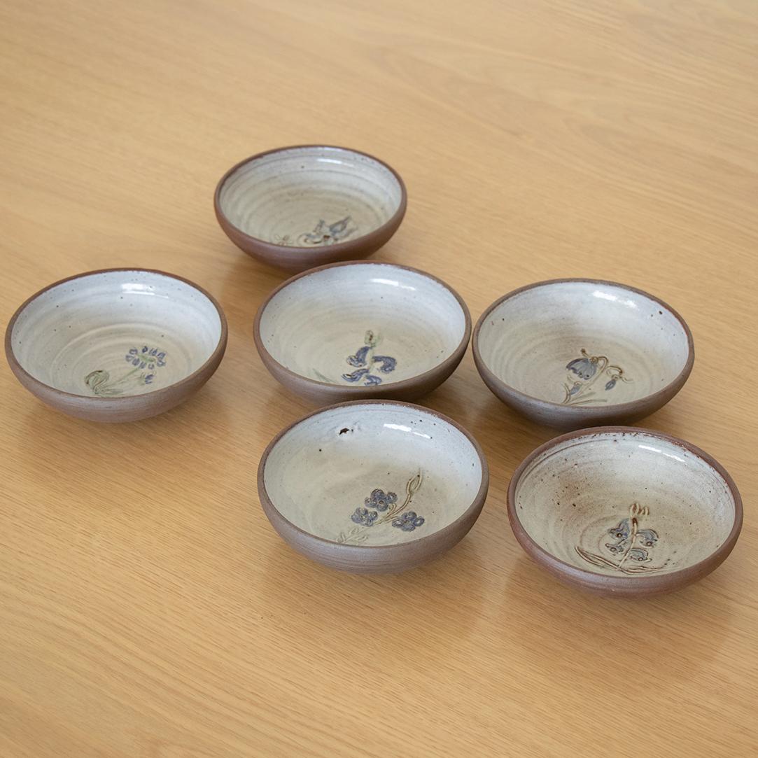 Lovely set of 6 small ceramic bowls made in France, 1960's. Dark brown clay bowl with interior light grey glaze and unique etched floral motifs on each. Perfect dessert bowl.
