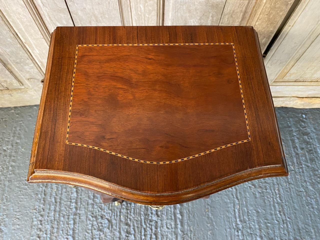 A lovely French bedside chest or ideal lamp table in a room. Made from kingwood with excellent gilded mounts and handles. The front is serpentine in form and the 4 drawers all run smoothly.
This lovely quality piece is in excellent condition having