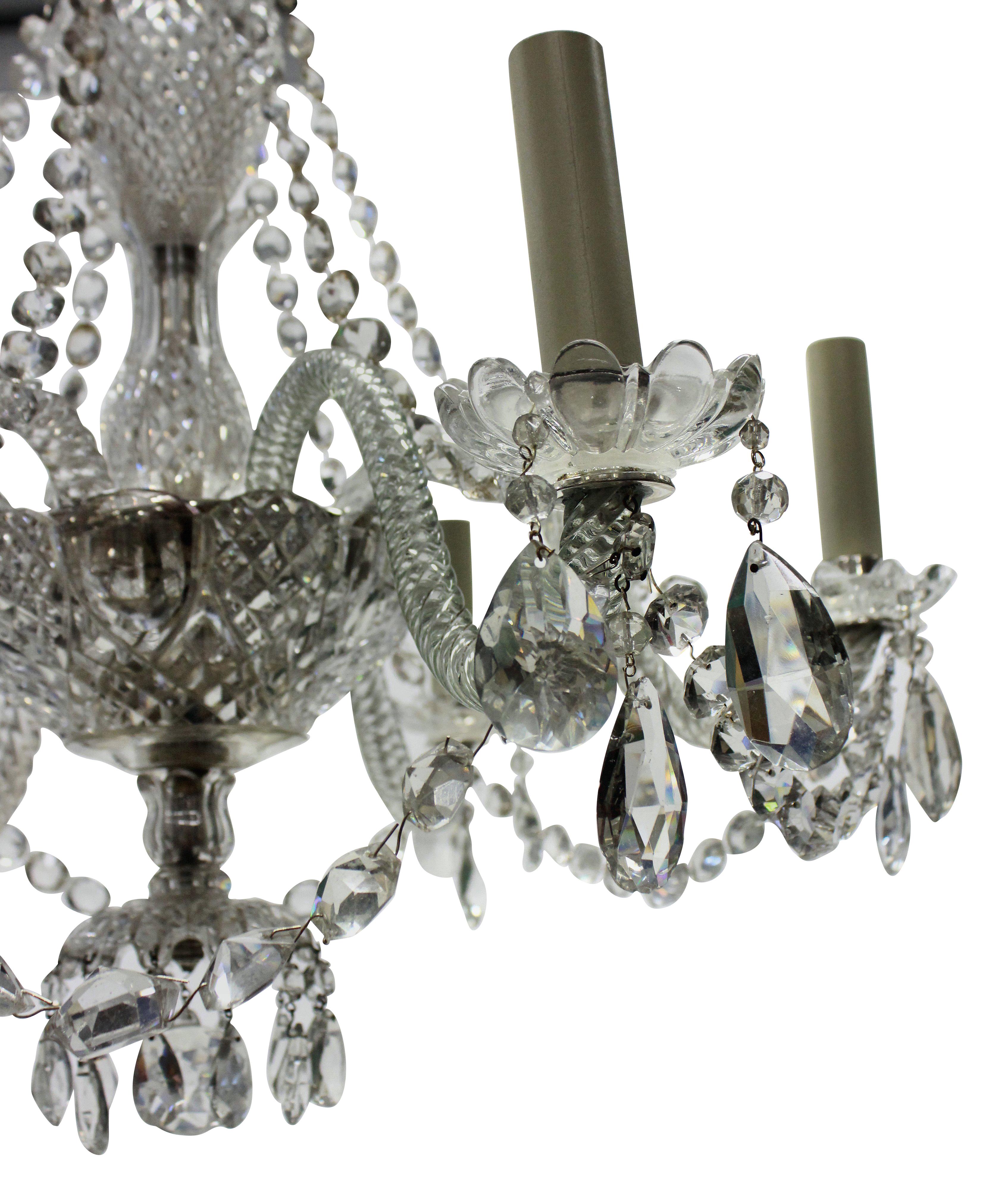 A French cut glass chandelier of smaller proportions for a lower ceiling. The glass of good quality.
