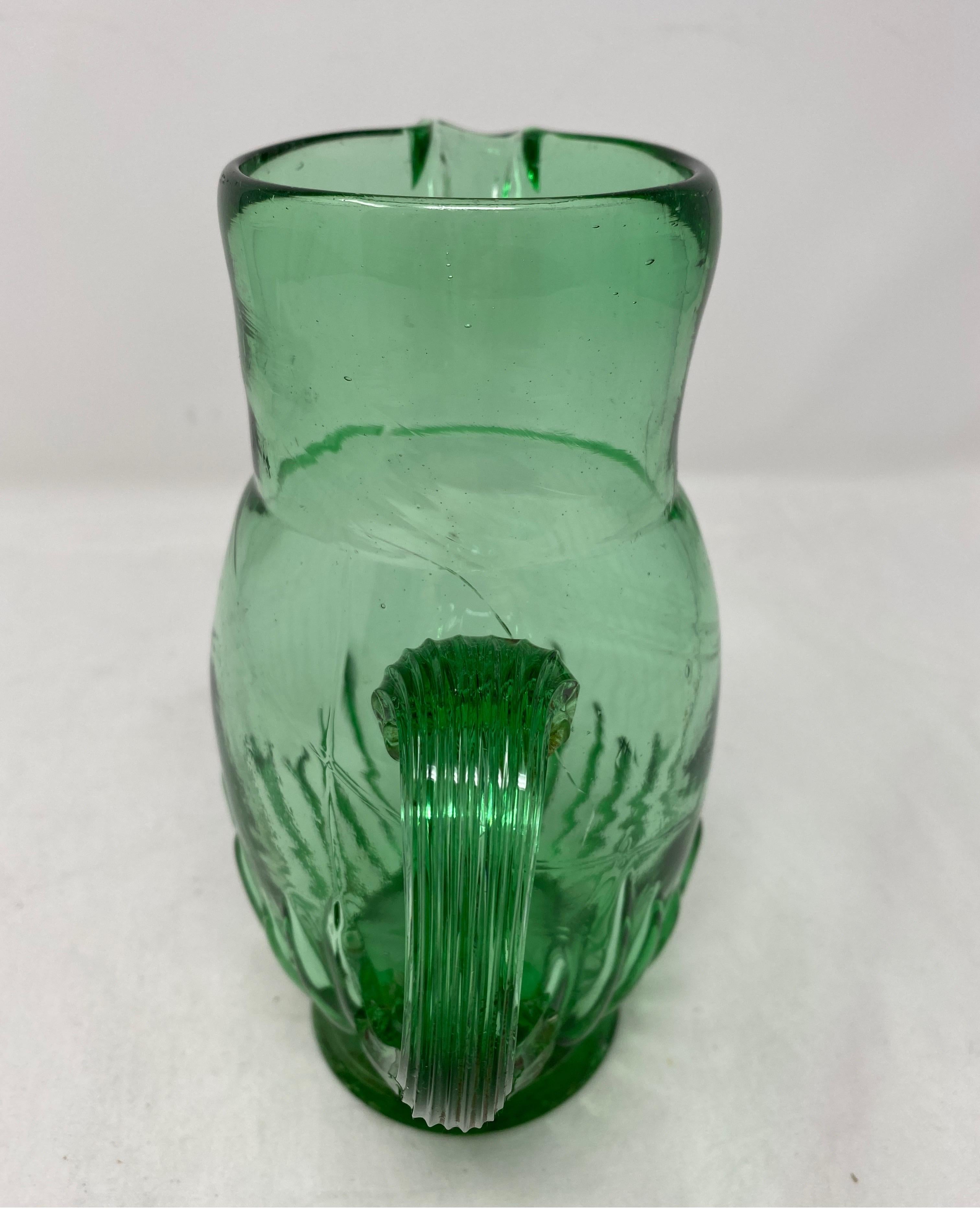 Small French green pitcher, 19th century. Air bubbles and a small crack present.
5