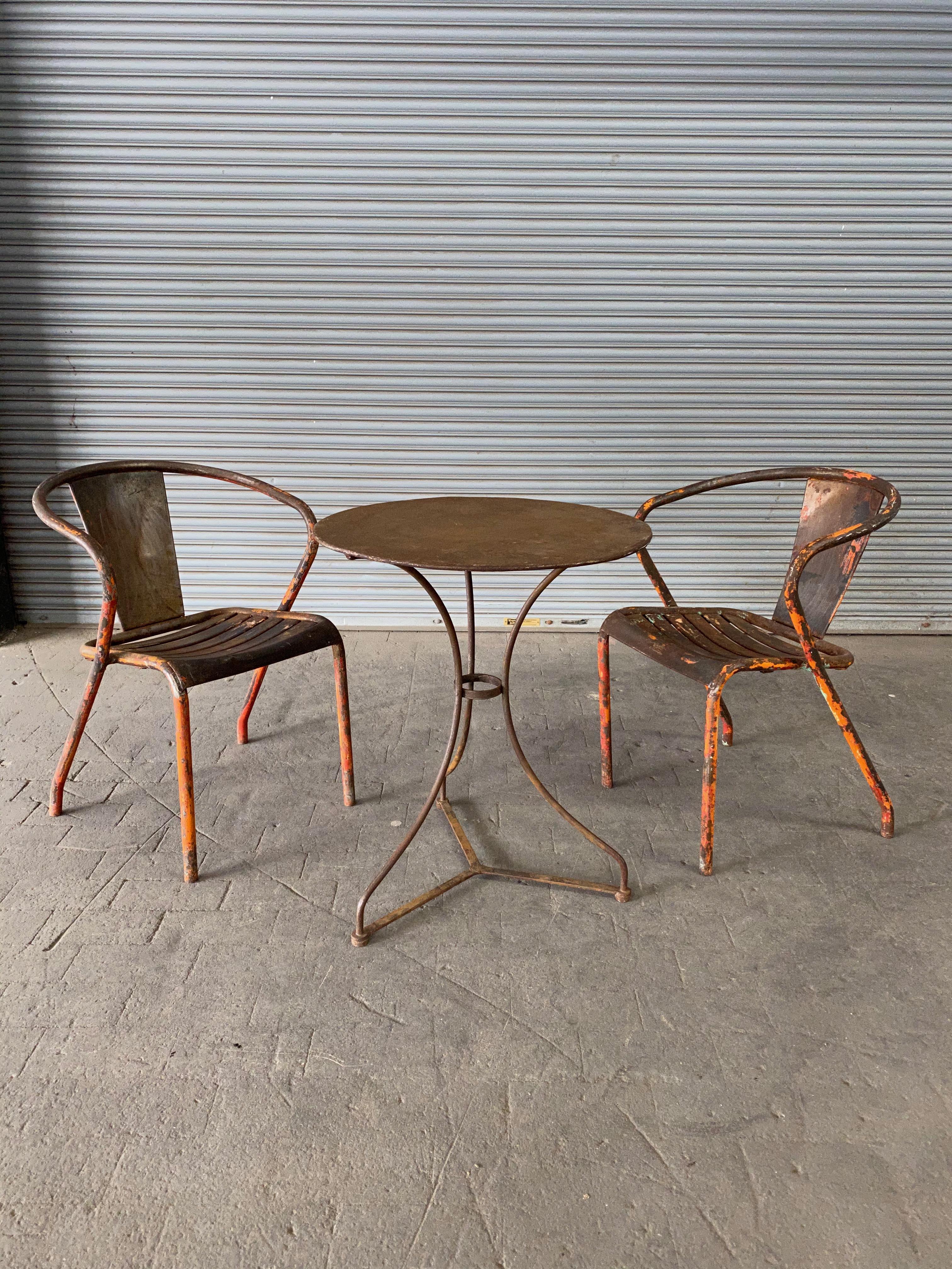 Small French garden table with a round top. The table has a rich rusted patina that has a coat of sealer on it to prevent further rusting, French, circa 1900.