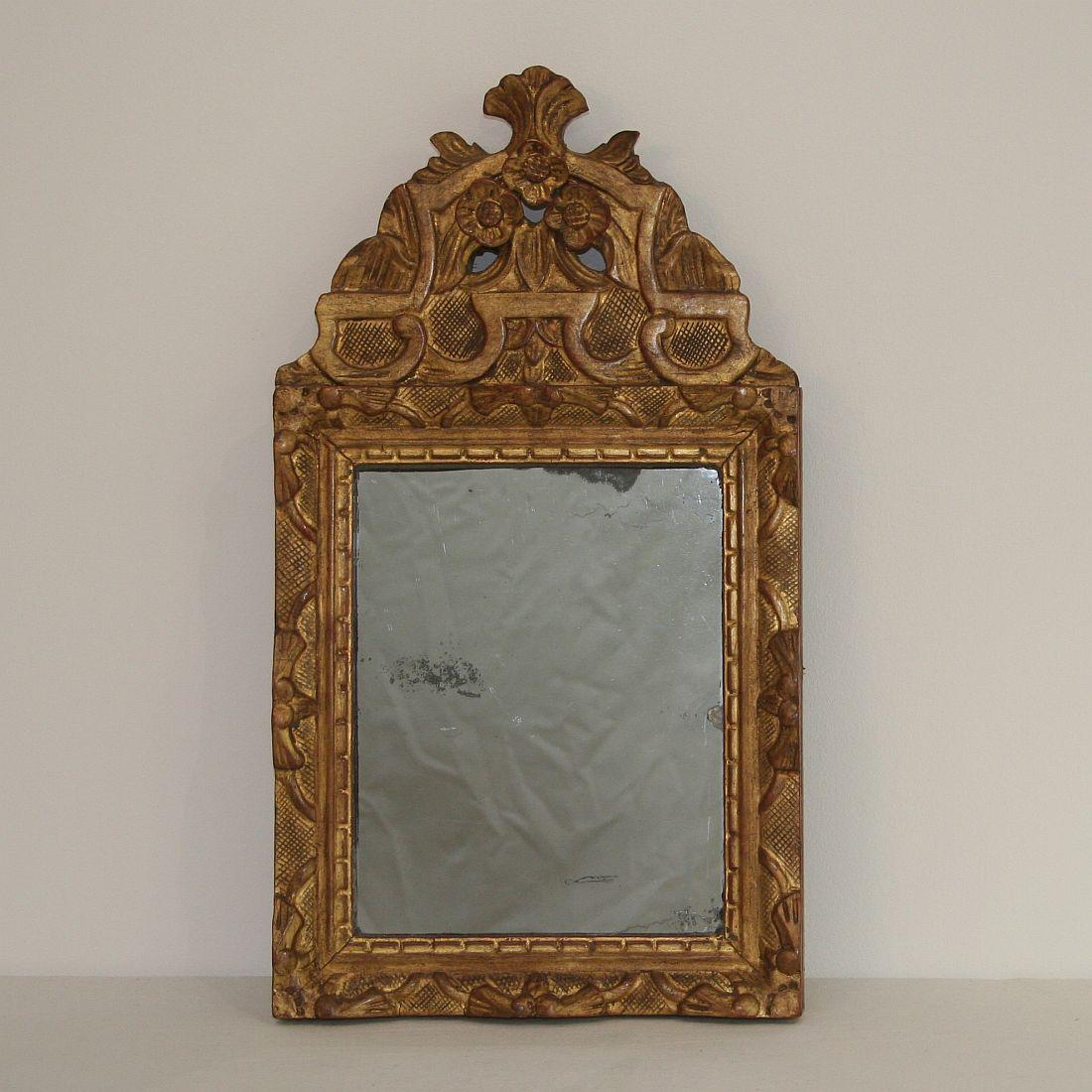 Small giltwood Louis XV baroque style mirror, France, circa 1850. Weathered.